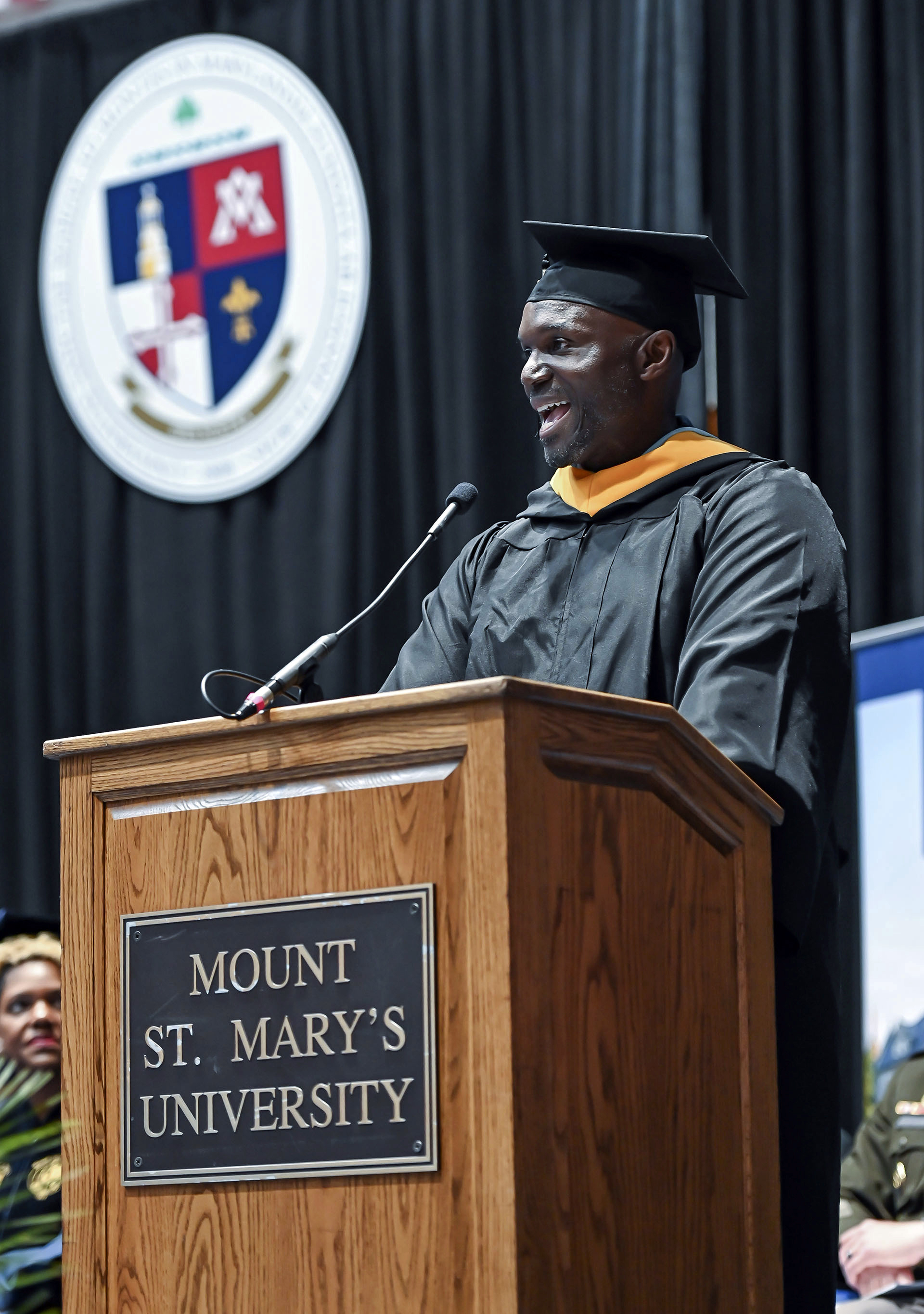 Tampa Bay Buccaneers head coach Todd Bowles speaks to the graduates and crowd at the 215th commencement exercise for of Mount St Mary's University, Saturday, May 13, 2023, in Emmitsburg, Md.. Bowles finished his degree in September of 2022 but wanted to walk the stage on Saturday. 