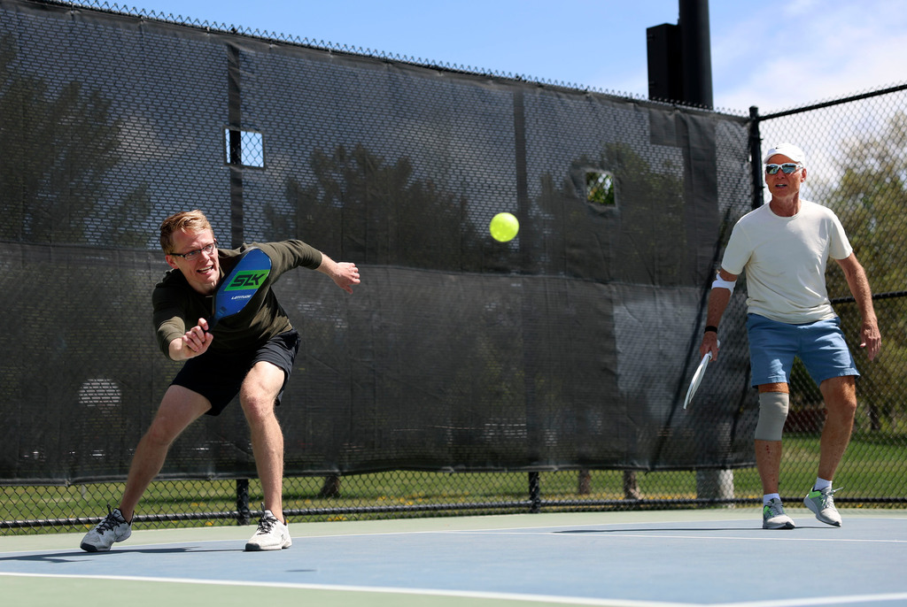 Jason Armstrong, left, and Rick Egan play pickleball at Fairmont Park in Salt Lake City on Friday.