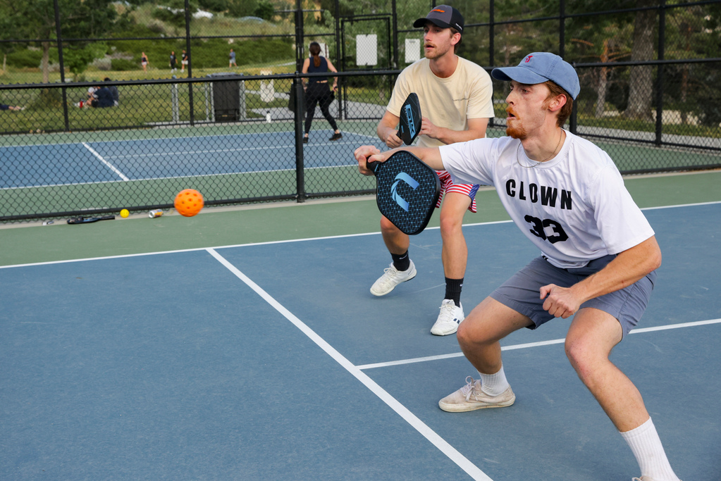 Theo Gardner-Puschak, right, returns a serve during a pickleball game at the 11th Avenue Park in Salt Lake City on June 30, 2022.