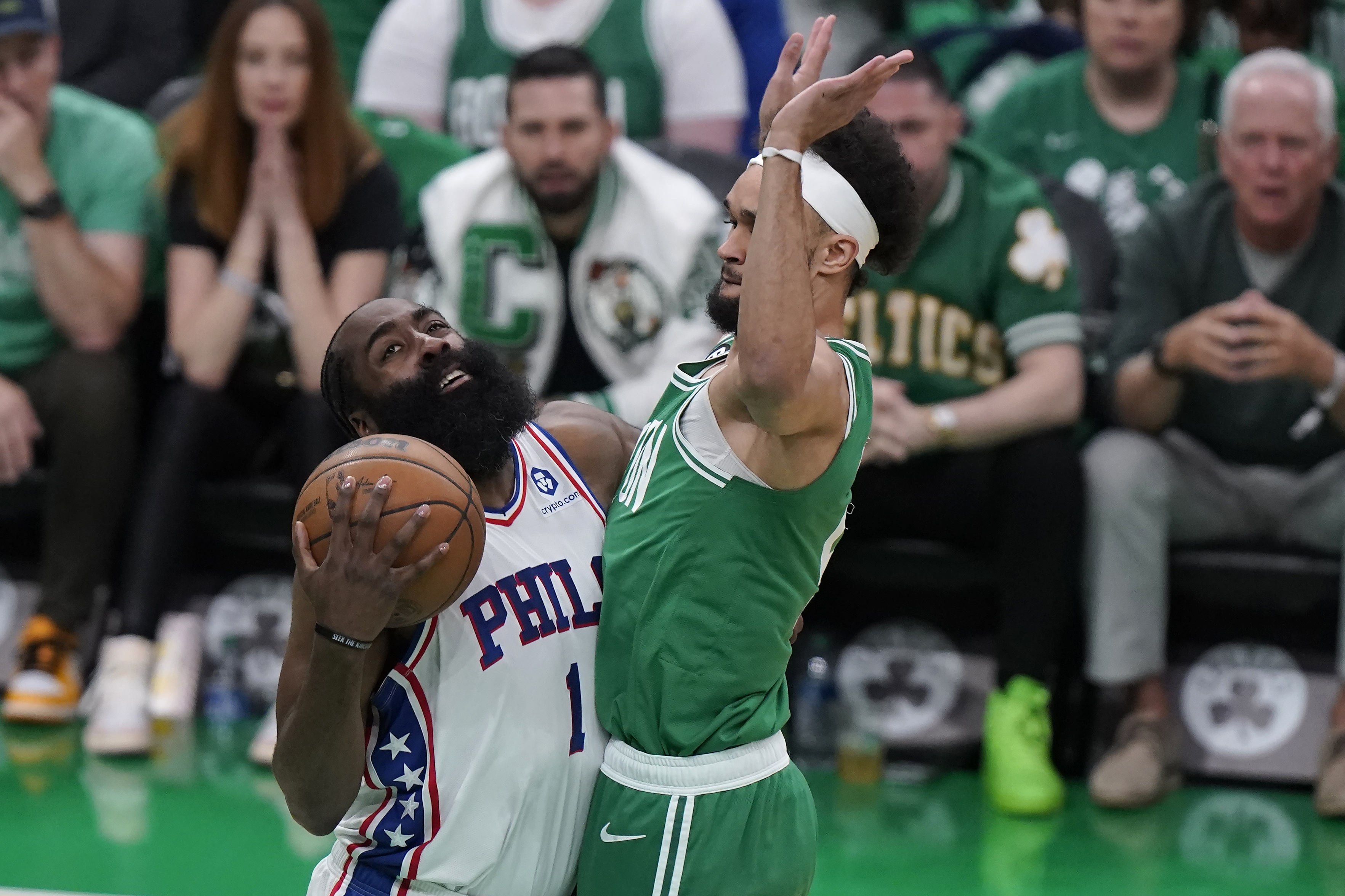 Philadelphia 76ers guard James Harden, left, vies for control of the ball with Boston Celtics guard Derrick White, right, during the first half of Game 7 in the NBA basketball Eastern Conference semifinal playoff series, Sunday, May 14, 2023, in Boston. 
