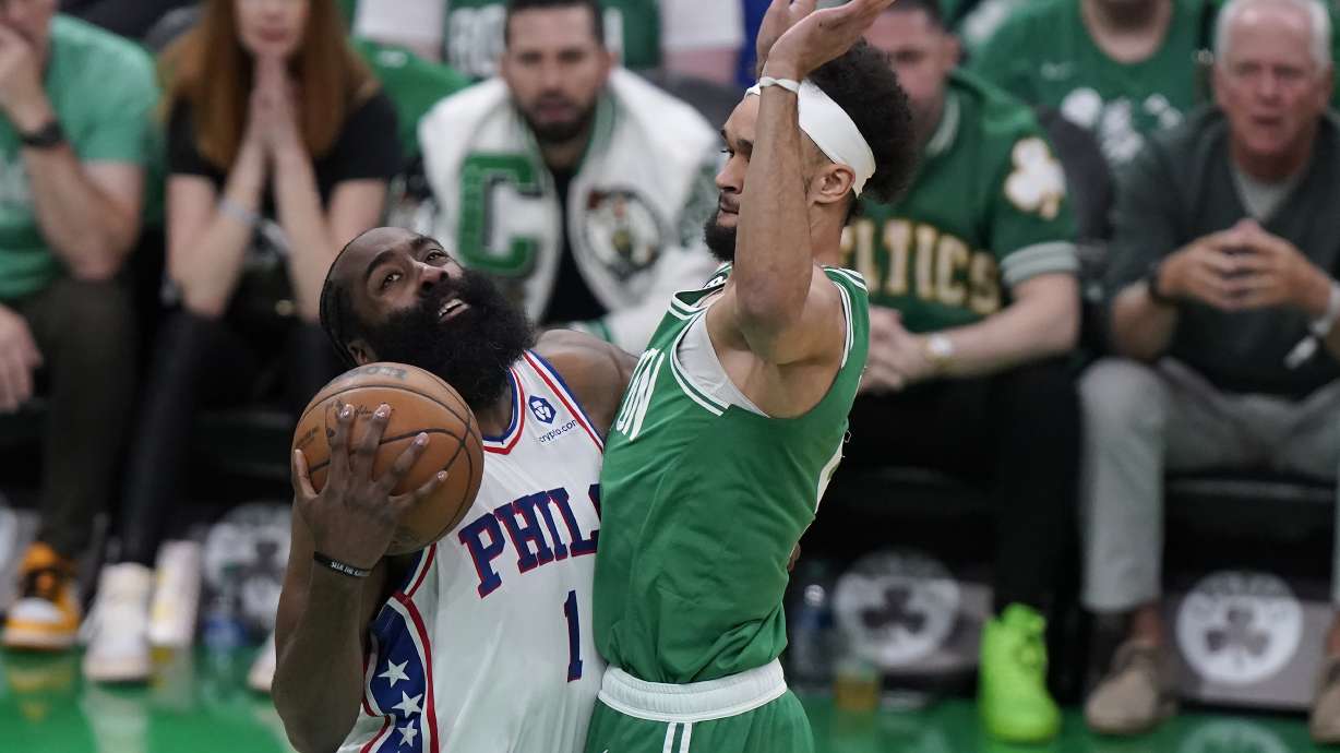 Philadelphia 76ers guard James Harden, left, vies for control of the ball with Boston Celtics guard Derrick White, right, during the first half of Game 7 in the NBA basketball Eastern Conference semifinal playoff series, Sunday, May 14, 2023, in Boston.