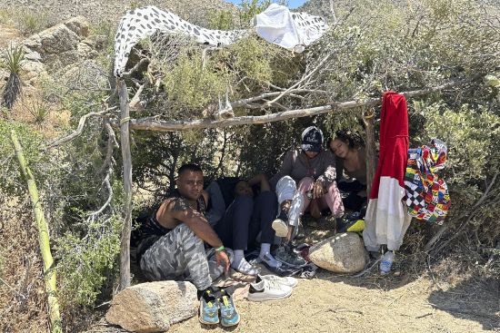 Teresa Muñoz, right, rests at a migrant shelter where she has been trying unsuccessfully for about a month to get an appointment to enter the United States through a new U.S. government mobile phone app in Tijuana, Mexico, May 11. She fled her home in the Mexican state of Michoacan after her husband was killed and she was badly beaten.