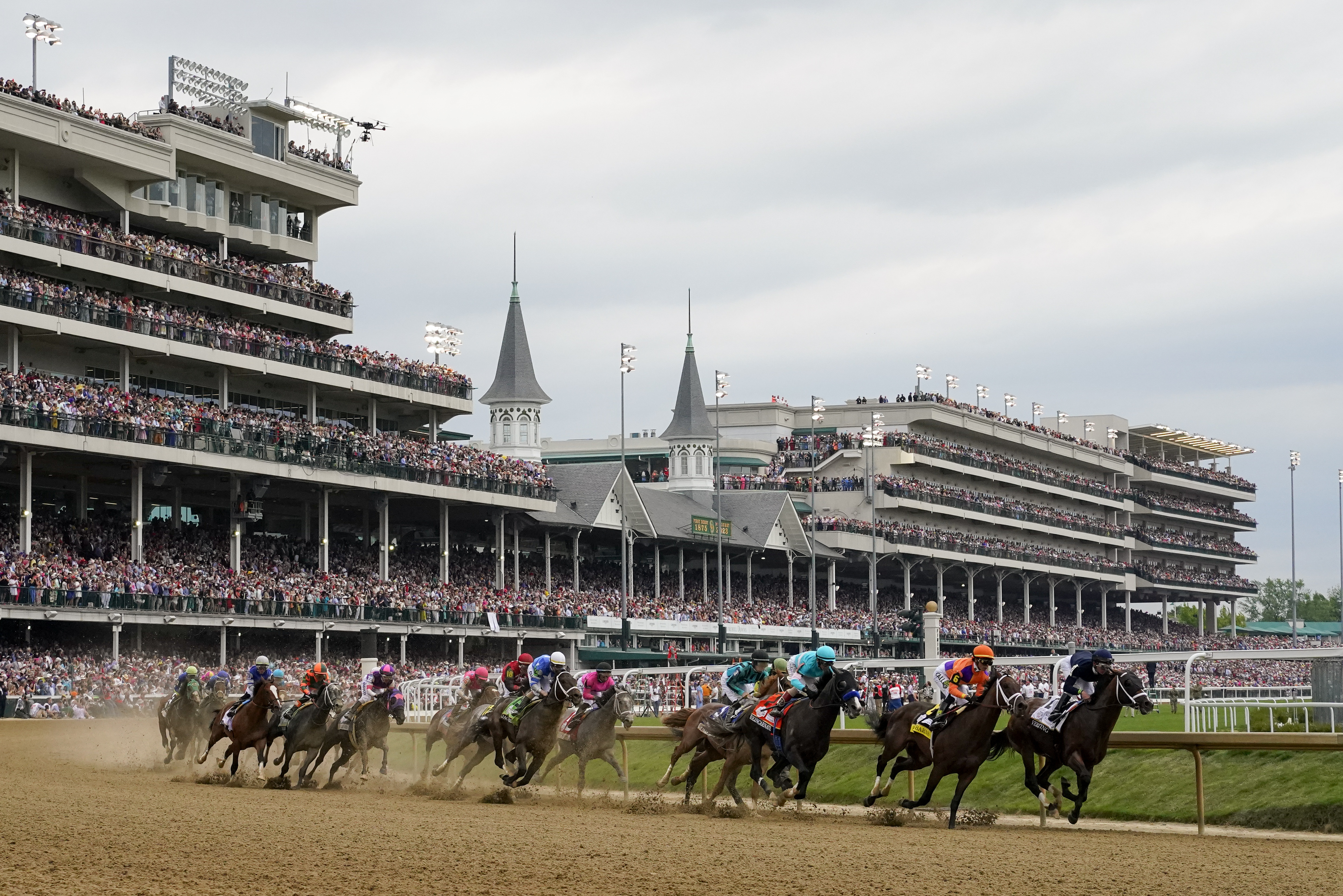 Horses come through the first turn during the 149th running of the Kentucky Derby horse race at Churchill Downs Saturday, May 6, 2023, in Louisville, Ky. 