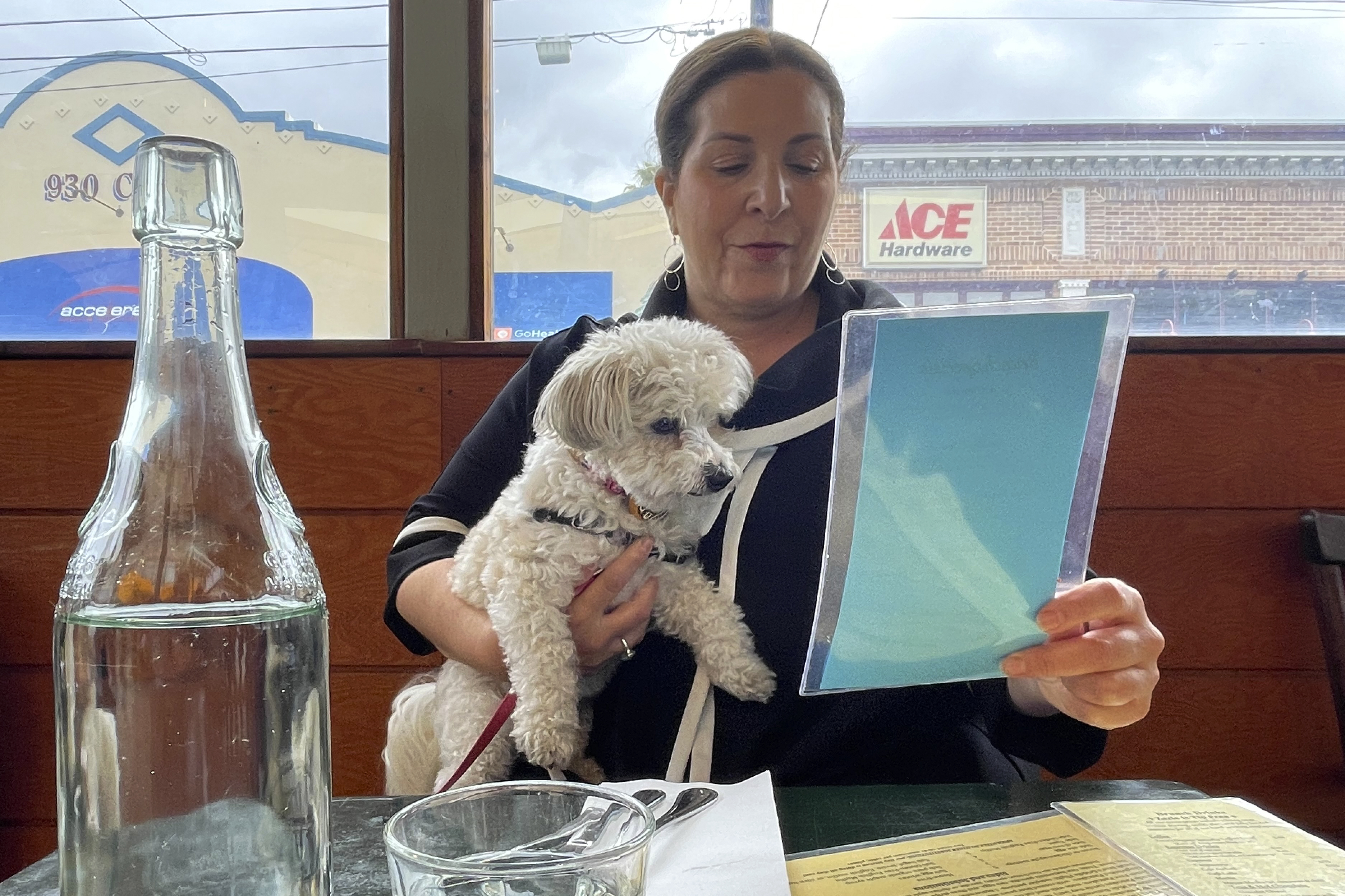 Ilana Minkoff checks out the menu with her dog JoJo Wigglebutt at a restaurant in San Francisco on May 5. Just in time for the summer dining season, the U.S. government has given its blessing to restaurants that want to allow pet dogs in their outdoor spaces.