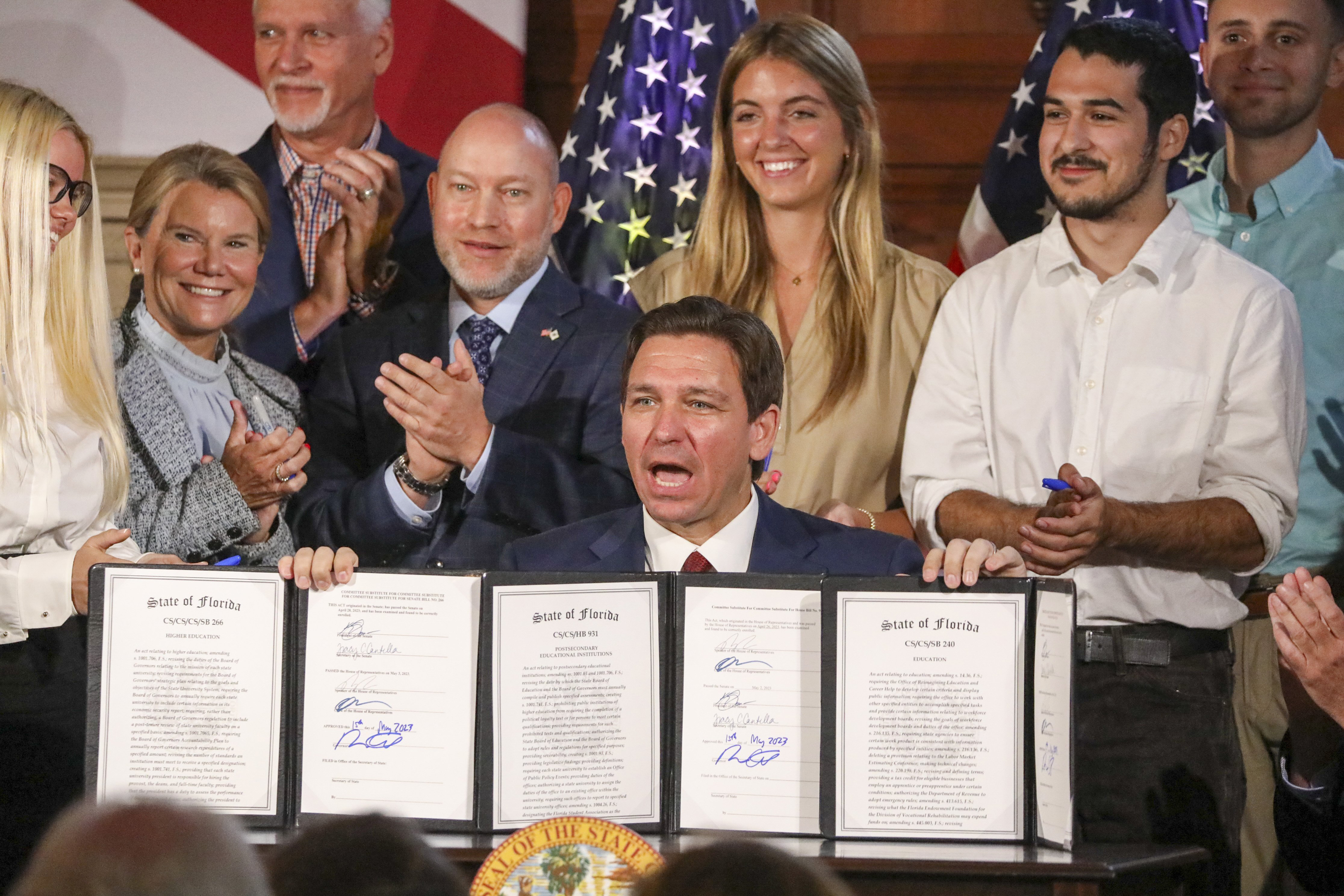 Florida Gov. Ron DeSantis signs legislation on Monday, banning state funding for diversity, equity and inclusion programs at Florida's public universities, at New College of Florida in Sarasota, Fla.