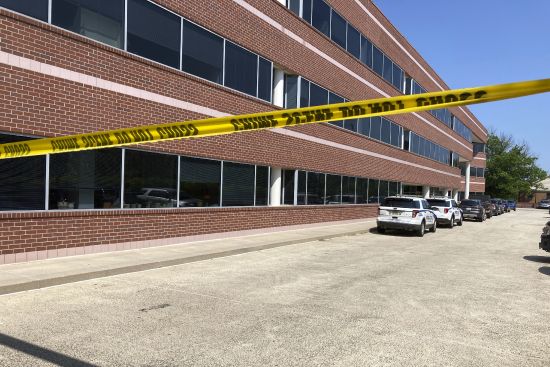 Crime scene tape blocks the Fairfax, Va., office building where police say a man wielding a baseball bat attacked two staffers for U.S. Rep. Gerry on Monday.