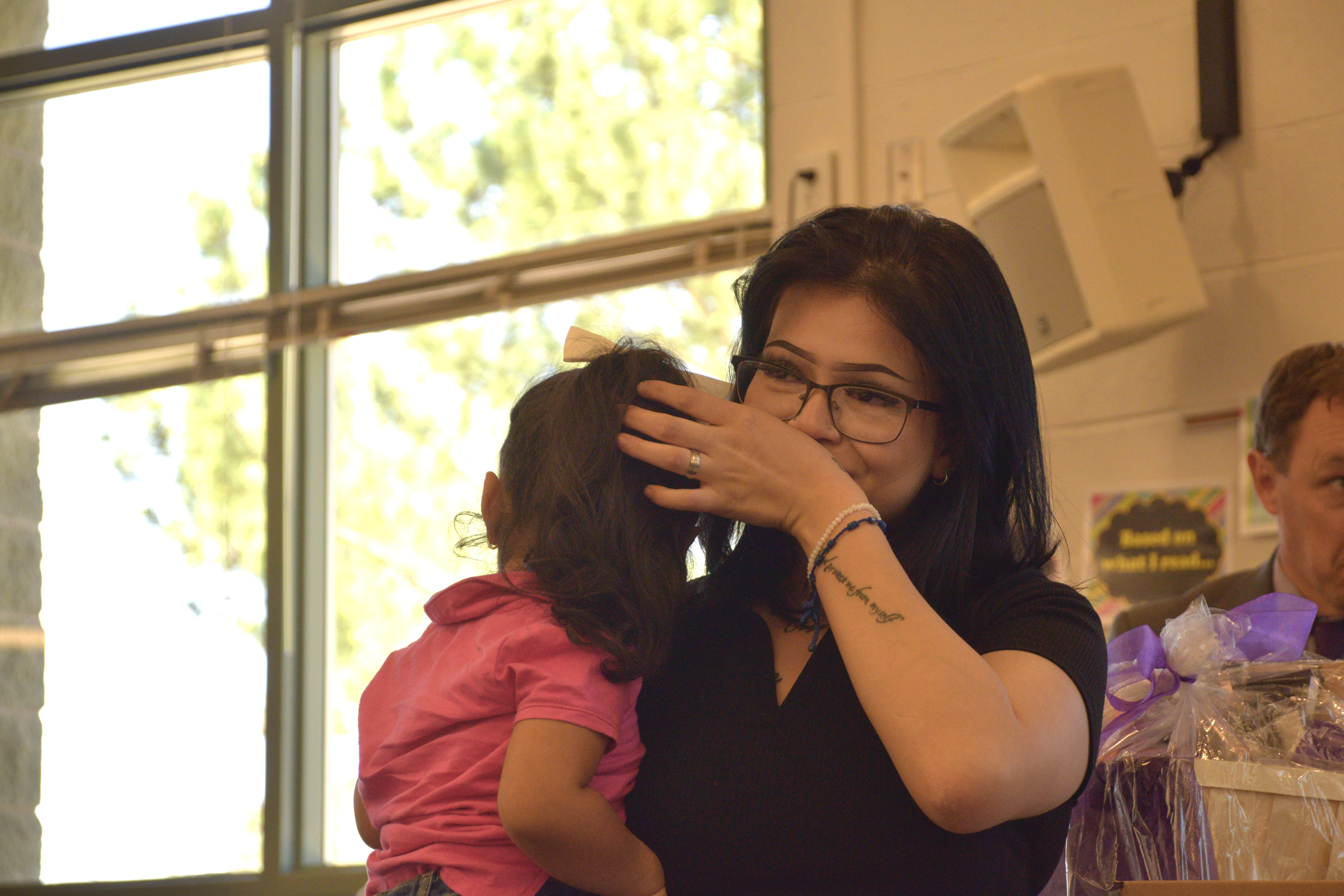 Angie Gonzalez, a senior at Granite Connection High School, reacts to being named as the district’s Absolutely Incredible Kid on Monday for persevering through challenges on her path to graduation during a ceremony Monday.