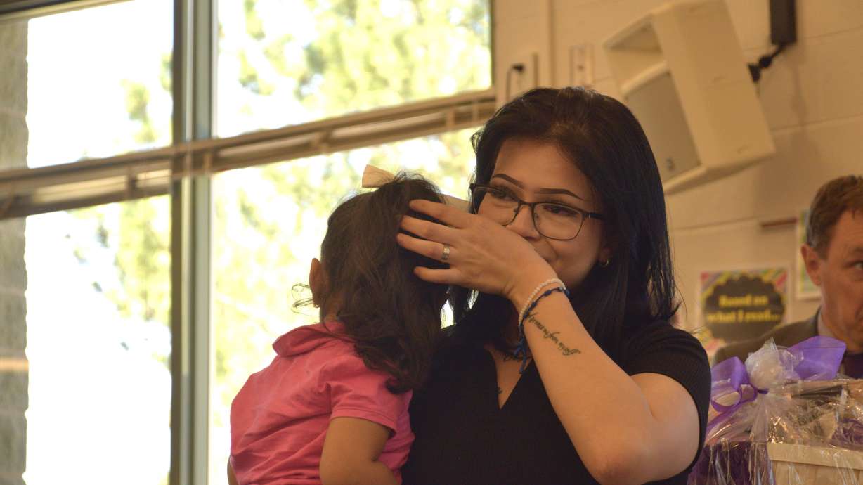 Angie Gonzalez, a senior at Granite Connection High School, reacts to being named as the district’s Absolutely Incredible Kid on Monday for persevering through challenges on her path to graduation during a ceremony Monday.