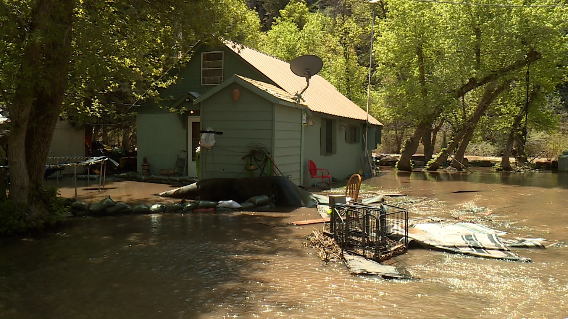 The South Fork Ogden River continues to spill over its banks, threatening homes and property. That's why the community was out Monday working together to redirect those waters and minimize the damage.