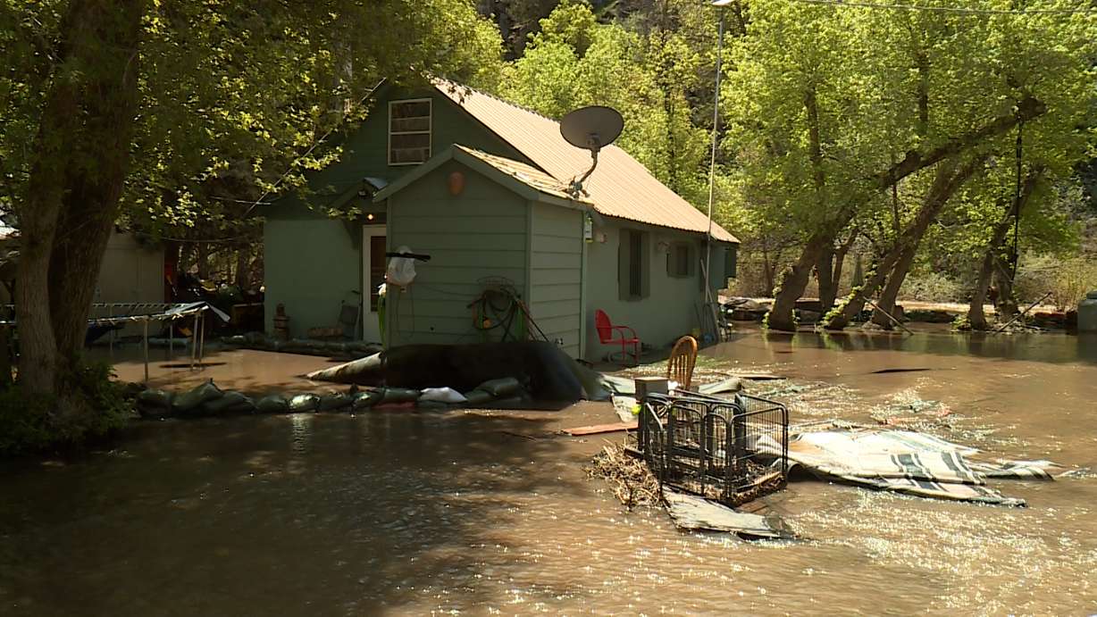 The South Fork Ogden River continues to spill over its banks, threatening homes and property. That's why the community was out Monday working together to redirect those waters and minimize the damage.