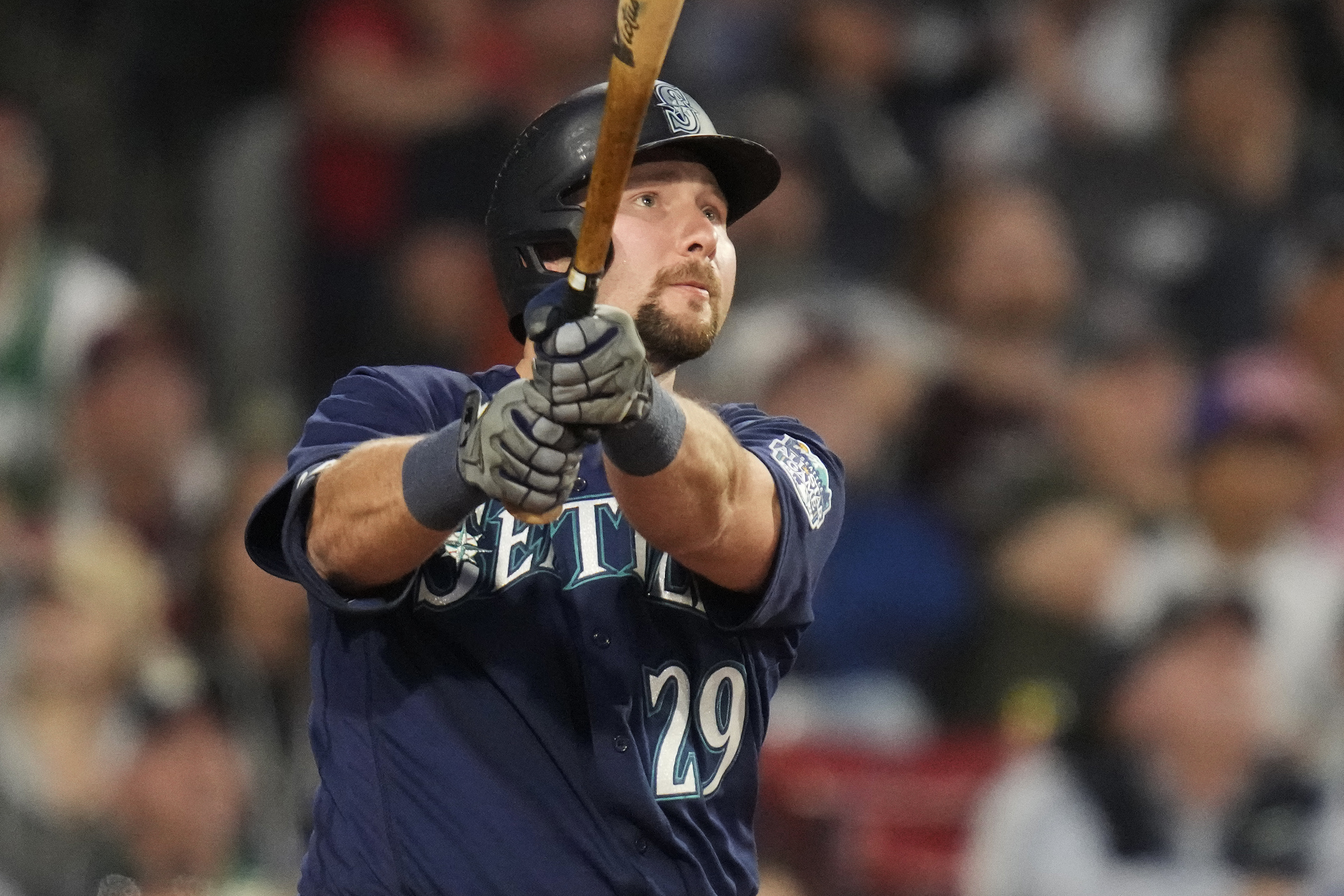 Seattle Mariners' Cal Raleigh watches the flight of his two-run home run off Boston Red Sox starting pitcher Tanner Houck during the fifth inning of a baseball game at Fenway Park, Monday, May 15, 2023, in Boston.