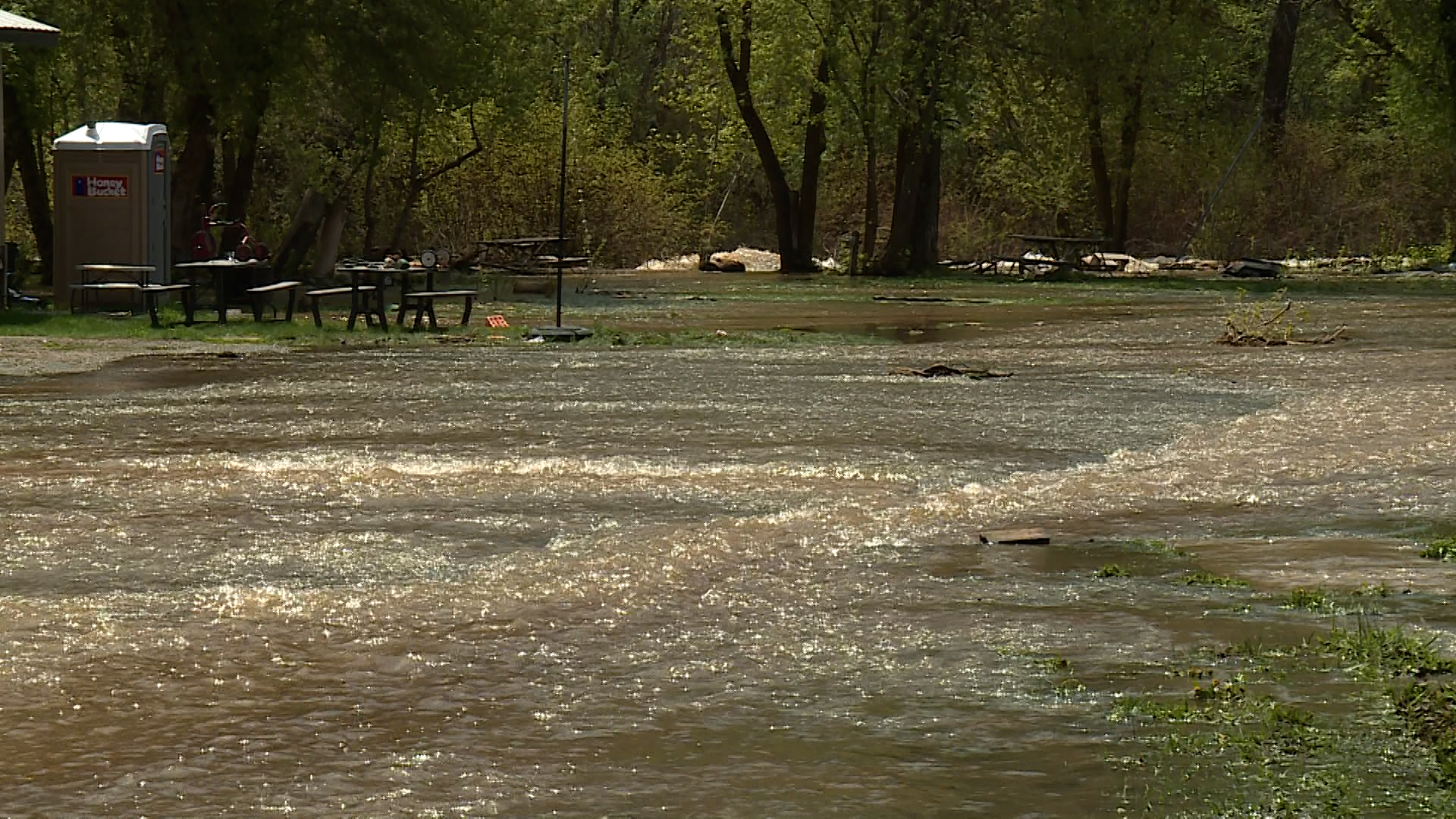 The South Fork Ogden River continues to spill over its banks, threatening homes and property. That's why the community was out Monday working together to redirect those waters and minimize the damage.
