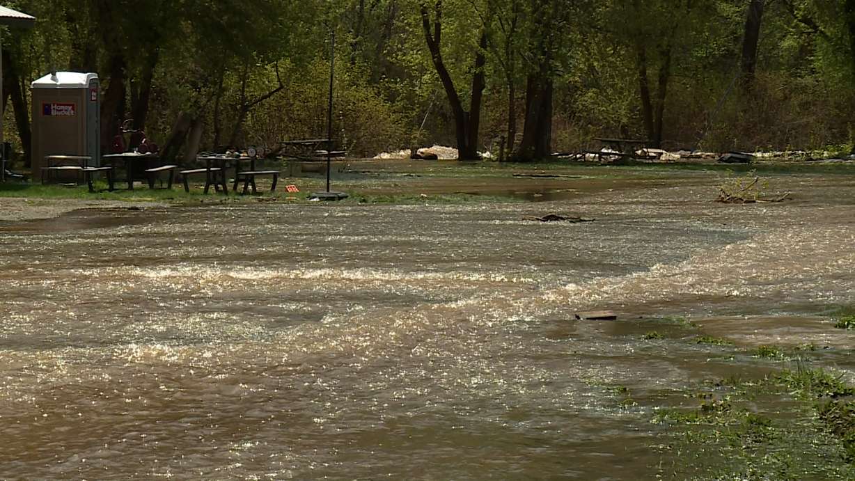 The South Fork Ogden River continues to spill over its banks, threatening homes and property. That's why the community was out Monday working together to redirect those waters and minimize the damage.