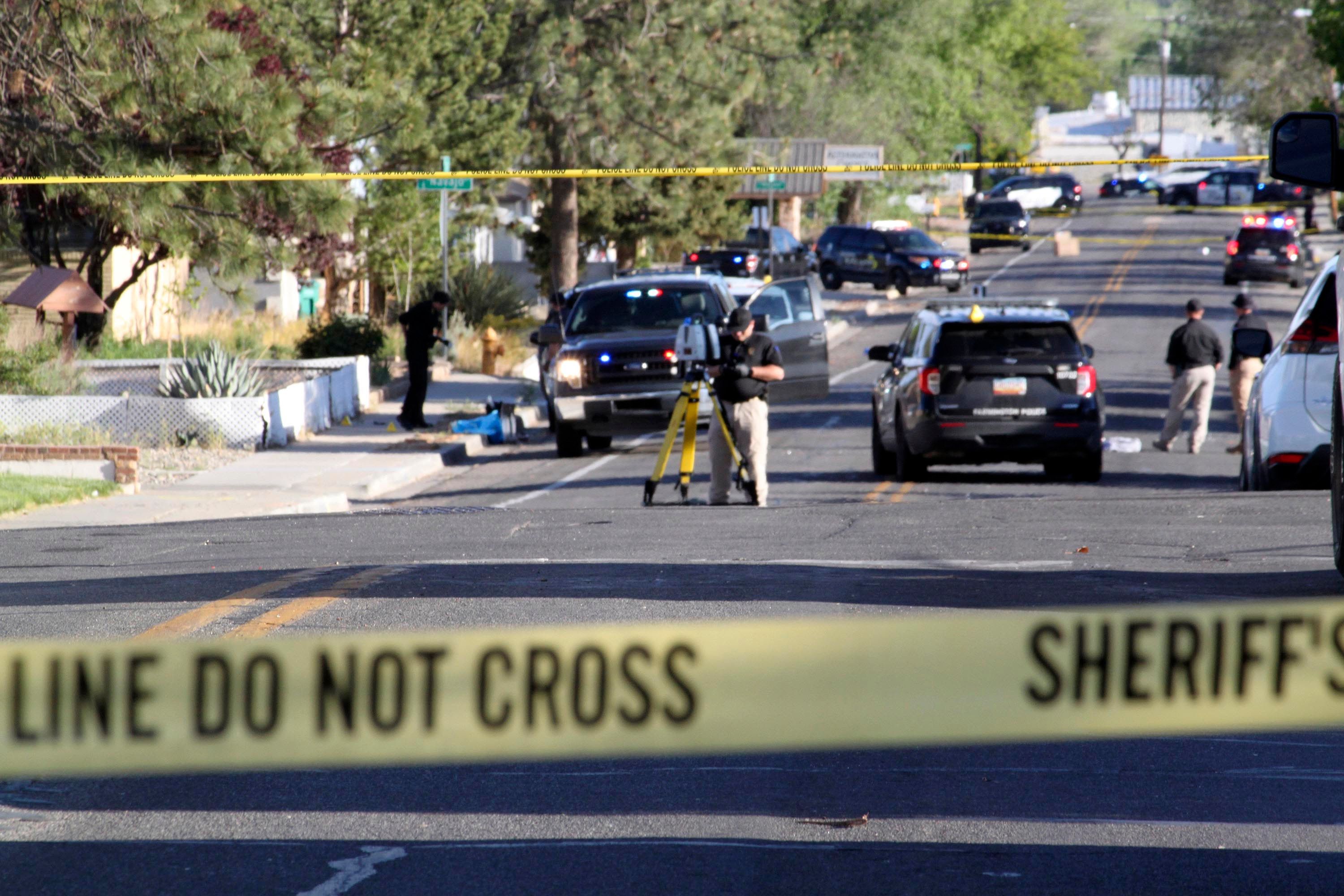 Investigators in Farmington, New Mexico, work Monday on a residential street after the shooting. Authorities on Tuesday identified Beau Wilson, 18, as the gunman who killed three people and wounded six others Monday.