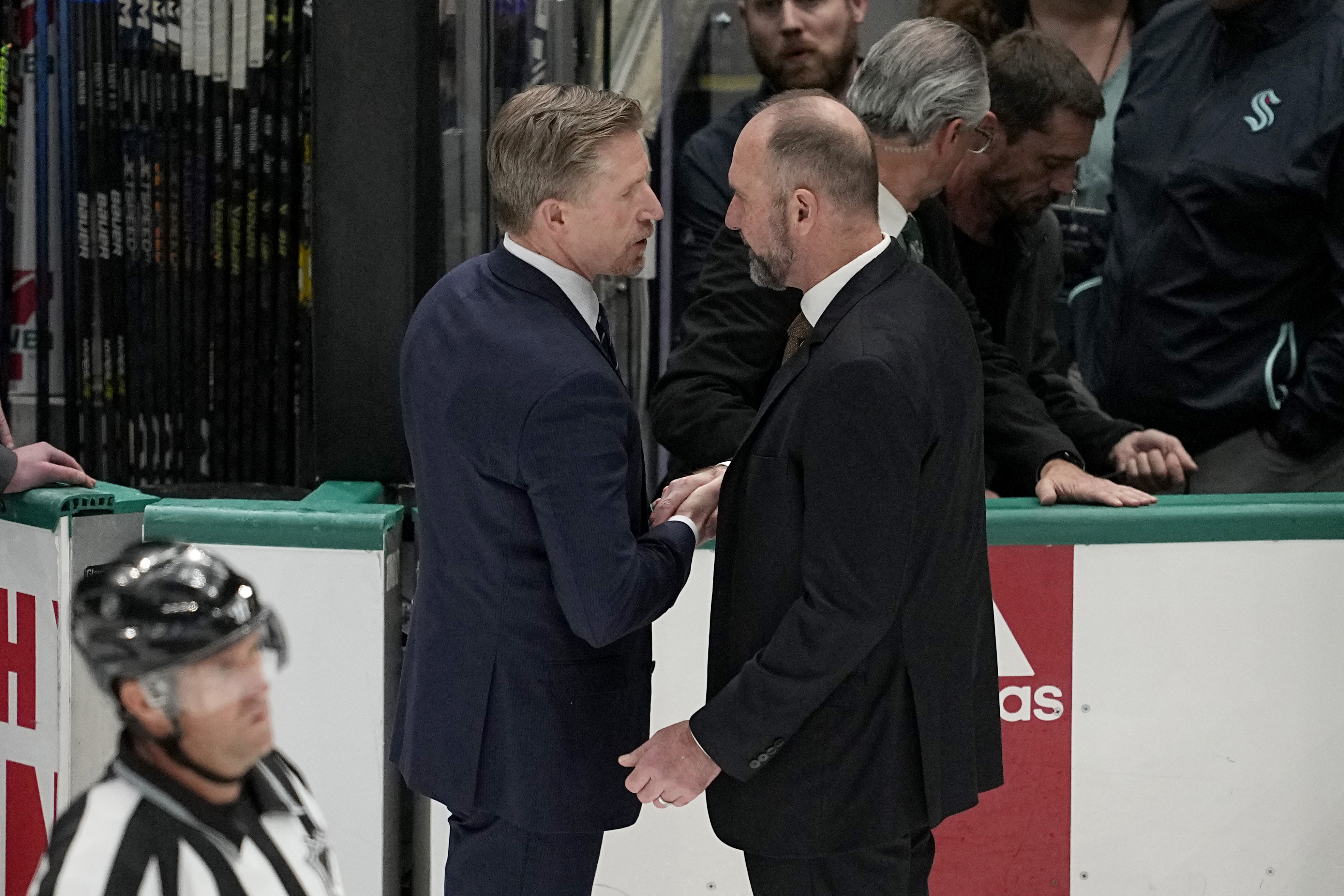 Seattle Kraken head coach Dave Hakstol, left, and Dallas Stars head coach Peter DeBoer, right, shake hands after Game 7 of an NHL hockey Stanley Cup second-round playoff series, Monday, May 15, 2023, in Dallas. 