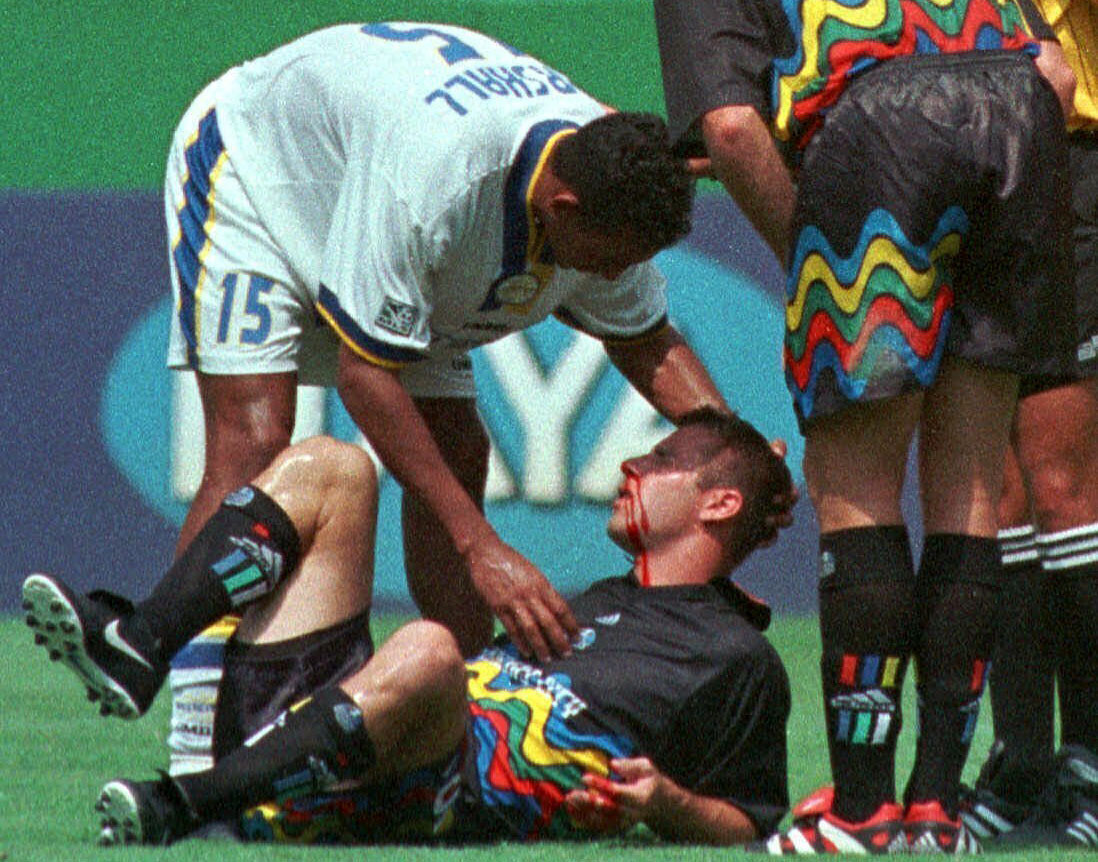 FILE - Miami Fusion's Tyrone Marshall (15) assists Kansas City Wizards' Scott Vermillion after the two collided while going up for a header in the first half of a soccer match Aug. 29, 1999, in Kansas City, Mo. Four more former professional soccer players have been diagnosed with chronic traumatic encephalopathy. The Concussion Legacy Foundation says they were found to have the degenerative brain disease that has been linked to concussions in athletes, combat veterans and others who have sustained repeated head trauma.