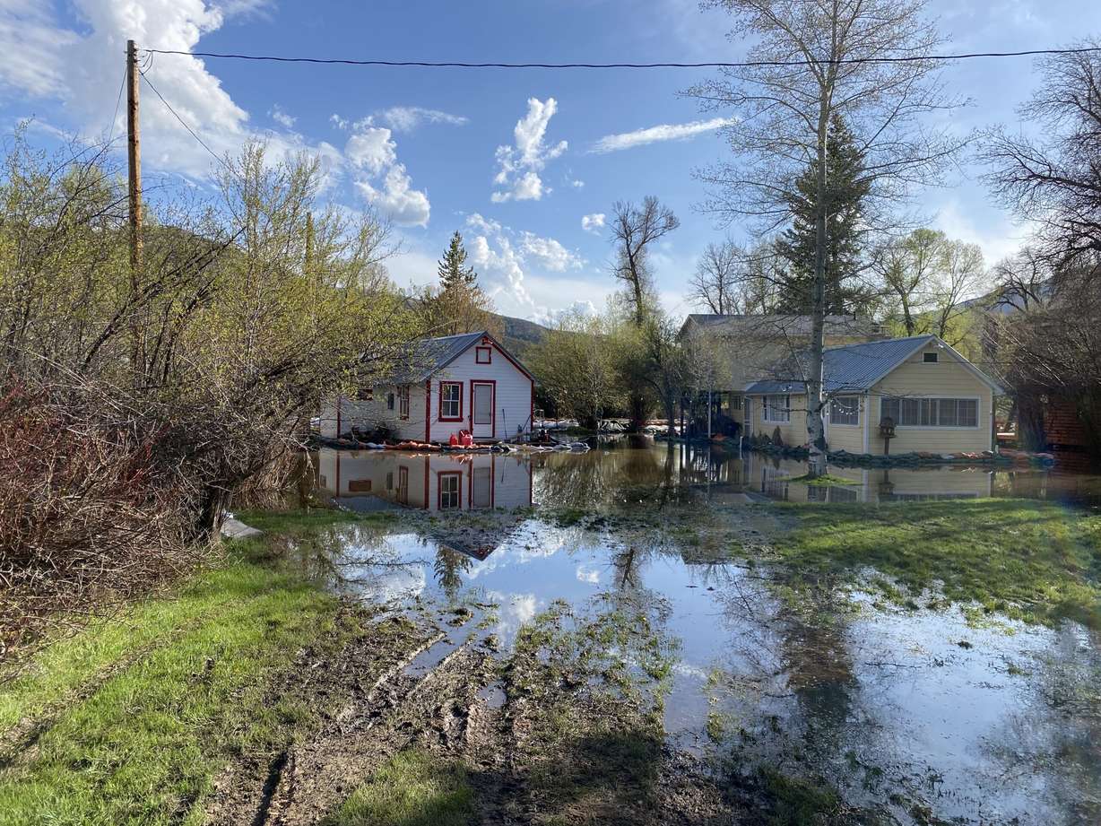 The South Fork Ogden River continues to spill over its banks, threatening homes and property. That's why the community was out Monday working together to redirect those waters and minimize the damage.