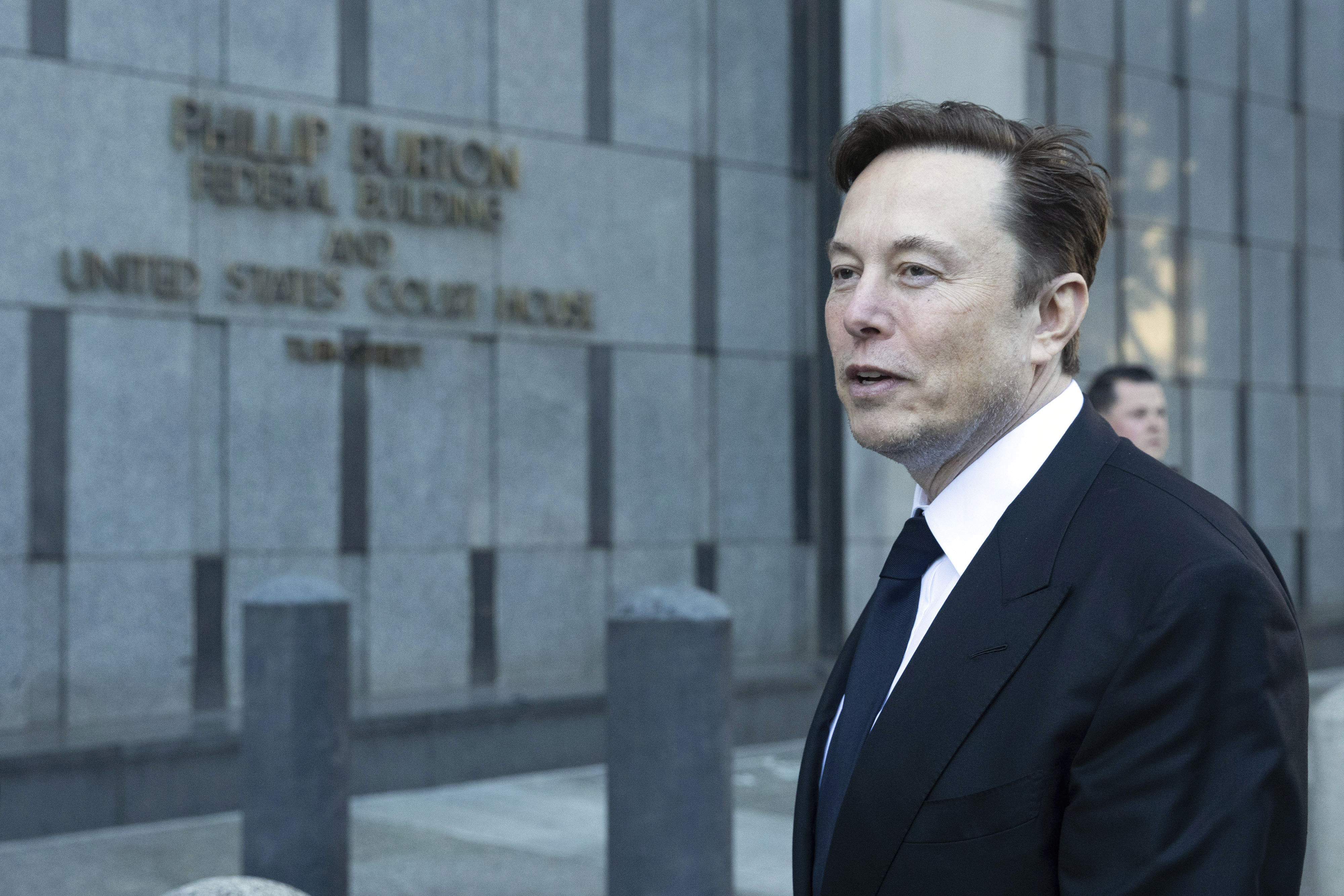 Elon Musk departs court in San Francisco, Jan. 24. Lawyers for Tesla are asking a federal appeals court to reconsider its ruling that Musk unlawfully threatened employees with a loss of stock options in a 2018 Twitter post amid a union organizing effort. 