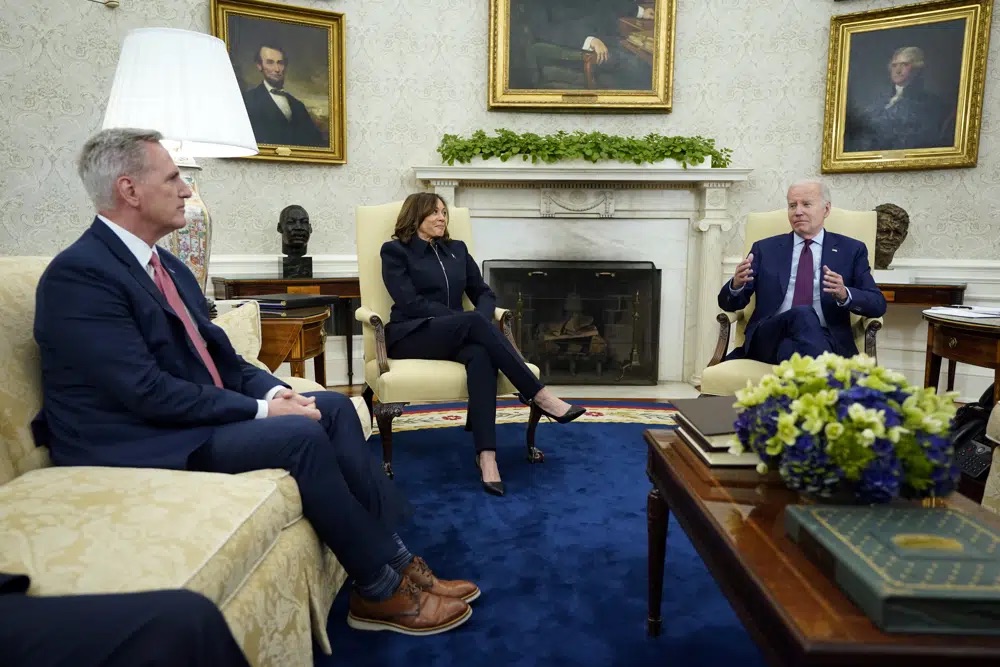 Speaker of the House Kevin McCarthy and Vice President Kamala Harris listen as President Joe Biden speaks in the Oval Office of the White House, Tuesday in Washington.