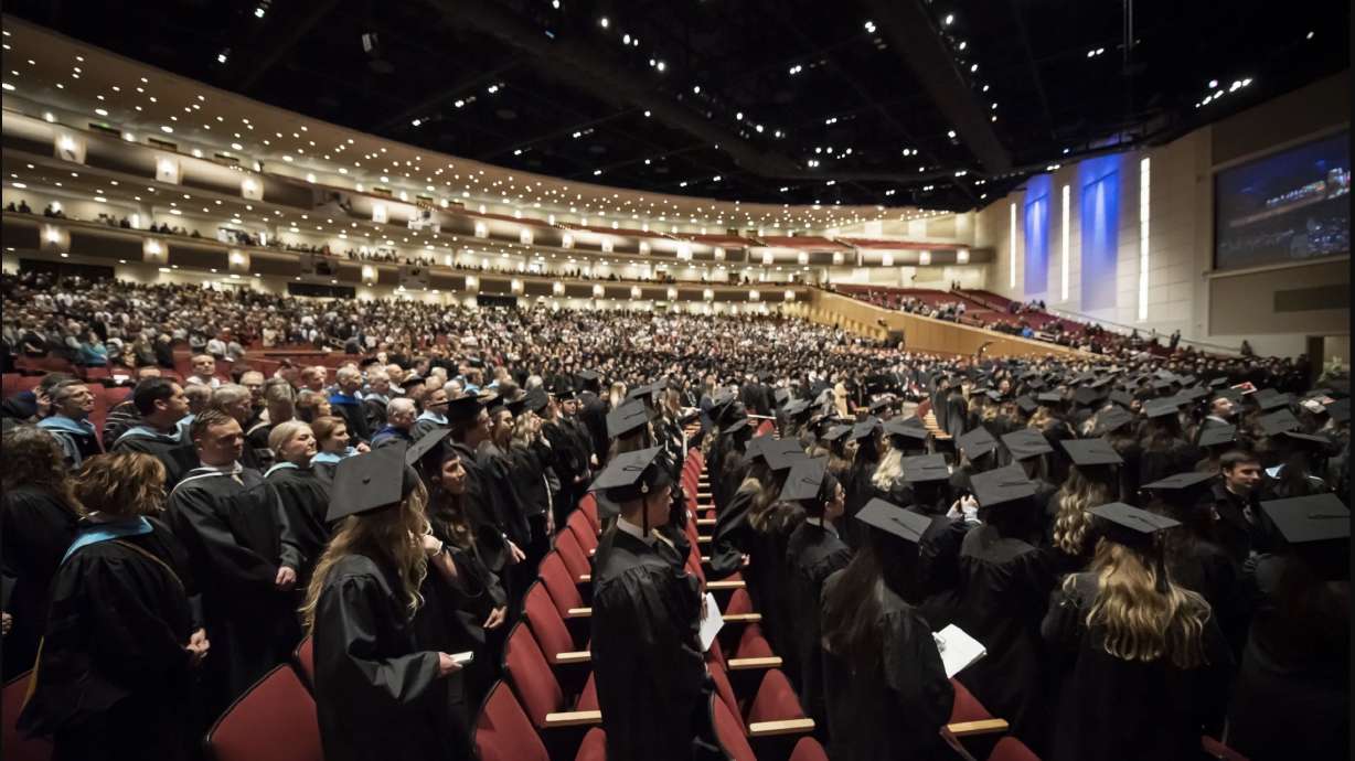 BYU-Idaho graduates stand in the I-Center for the fall 2022 commencement on Dec. 15, 2022, in Rexburg, Idaho. The school named a new president on Tuesday.
