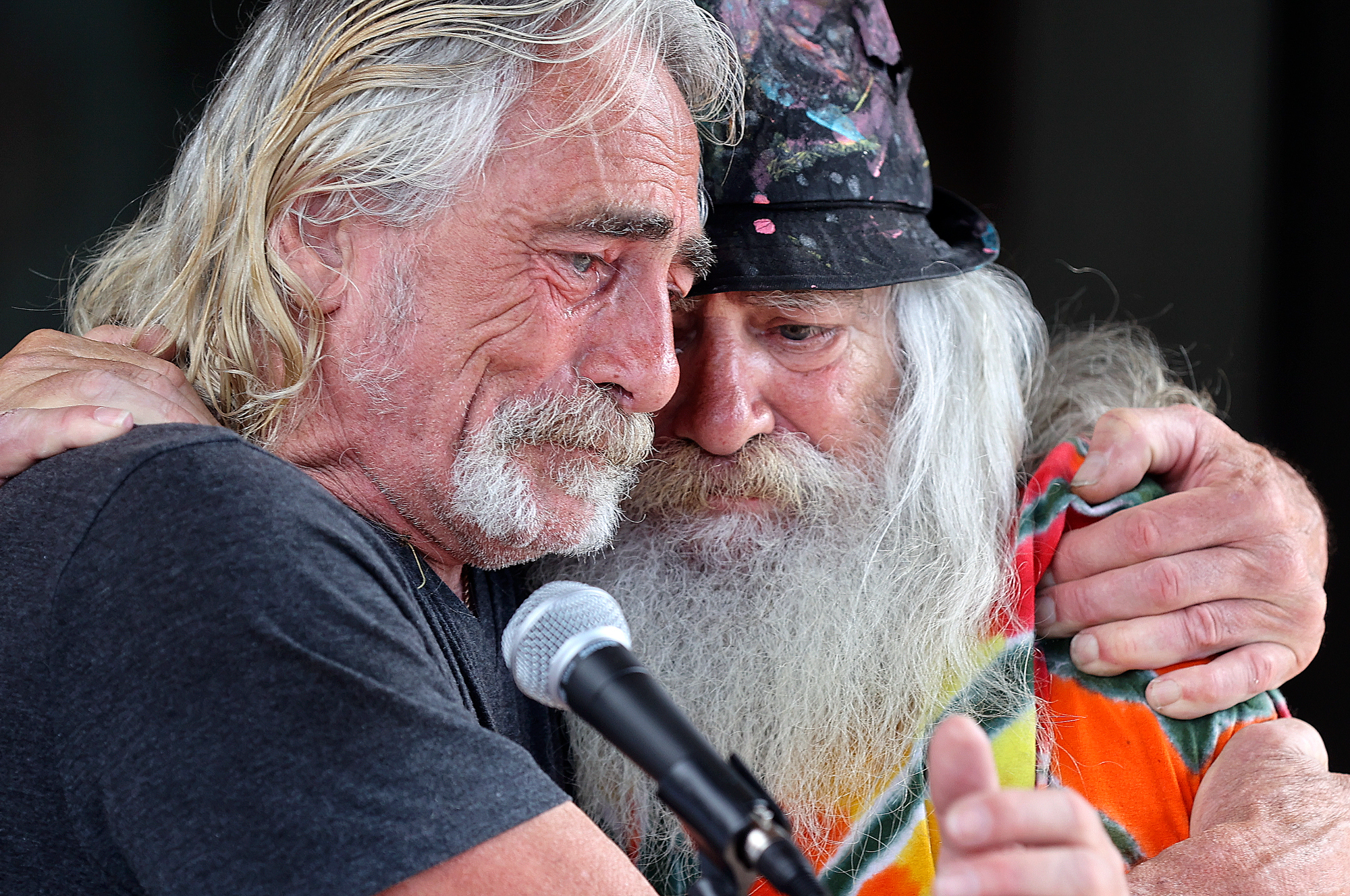 Chuck Layton, who recently had all of his toes amputated due to frostbite he endured while homeless this winter, hugs his brother Kevin Layton during a ribbon-cutting ceremony for a deeply affordable housing project in Salt Lake City on Tuesday.