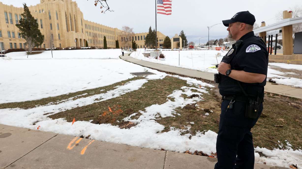 Ogden police officer Chavis Whitby stands outside of Ogden High School after false threats of shots fired on March 29. Lawmakers discussed the hoax on Tuesday.