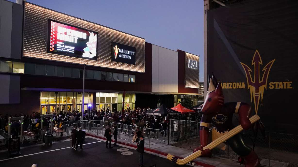 FILE - Arizona Coyotes fans wait for the doors to open prior to the Coyotes' home-opening NHL hockey game against the Winnipeg Jets at Mullett Arena in Tempe, Ariz., Oct. 28, 2022. The Coyotes are about to learn the fate of a proposed entertainment district that will include a new arena. A referendum going before voters in the city of Tempe will determine whether plans for the $2.3 billion Tempe Entertainment District will move forward.
