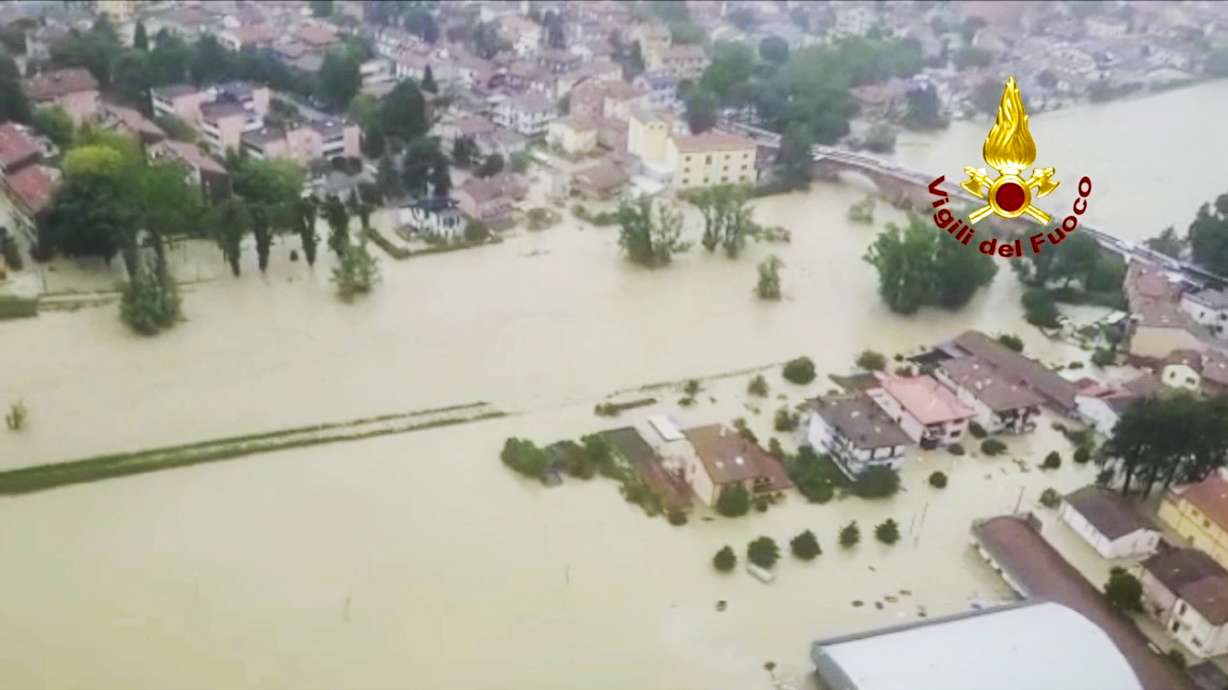 This aerial photo provided by the Italian Firefighters shows firefighters show flooded houses in Cesena, in the northern Italian region of Emilia Romagna Tuesday, May 16, 2023. Unusually heavy rains have caused major floodings in Emilia Romagna, where trains were stopped and schools were closed in many towns while people were asked to leave the ground floors of their homes and to avoid going out.