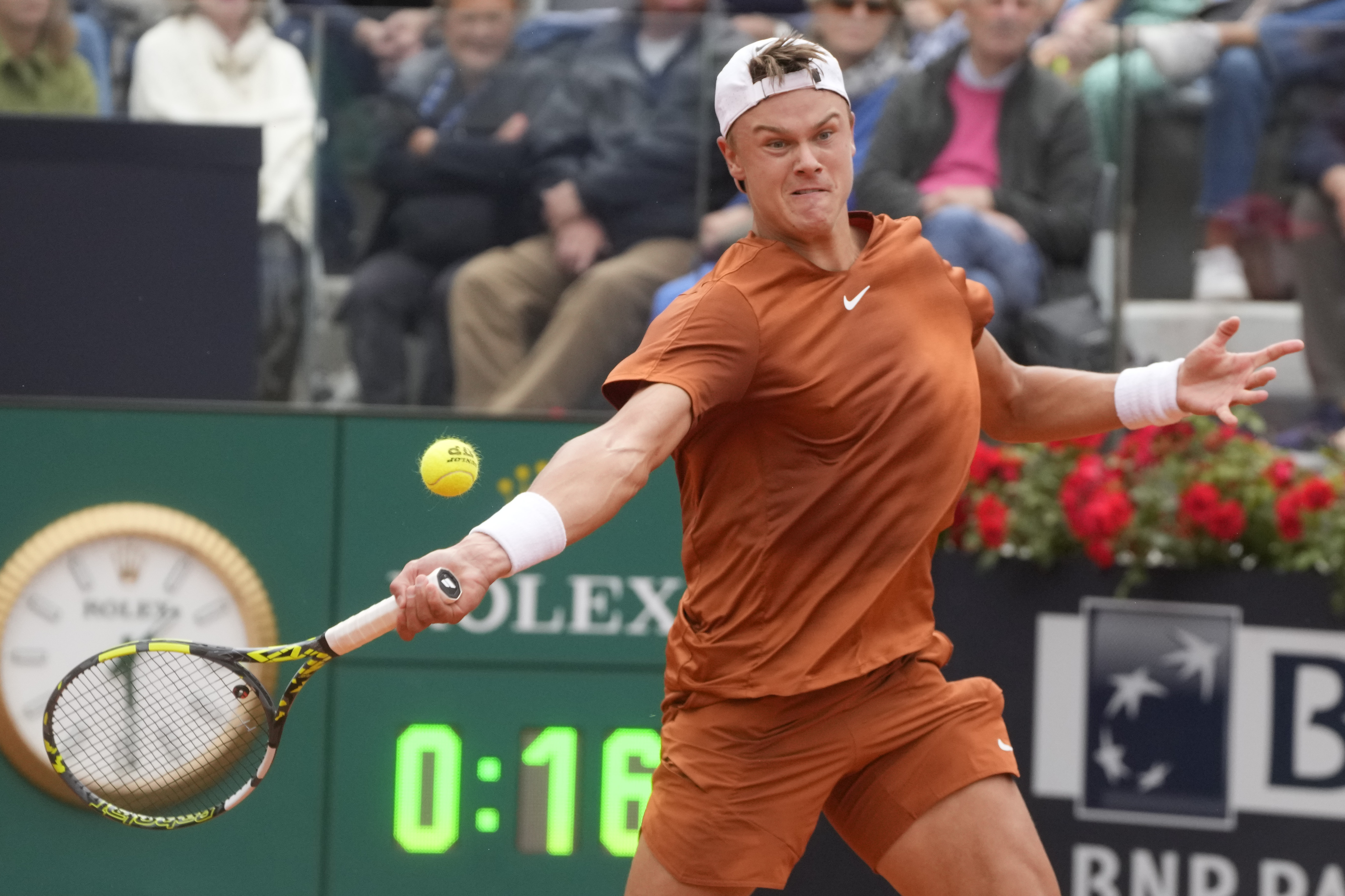 Denmark's Holger Rune returns the ball to Serbia's Novak Djokovic during their quarter final match at the Italian Open tennis tournament, in Rome, Wednesday, May 17, 2023. 