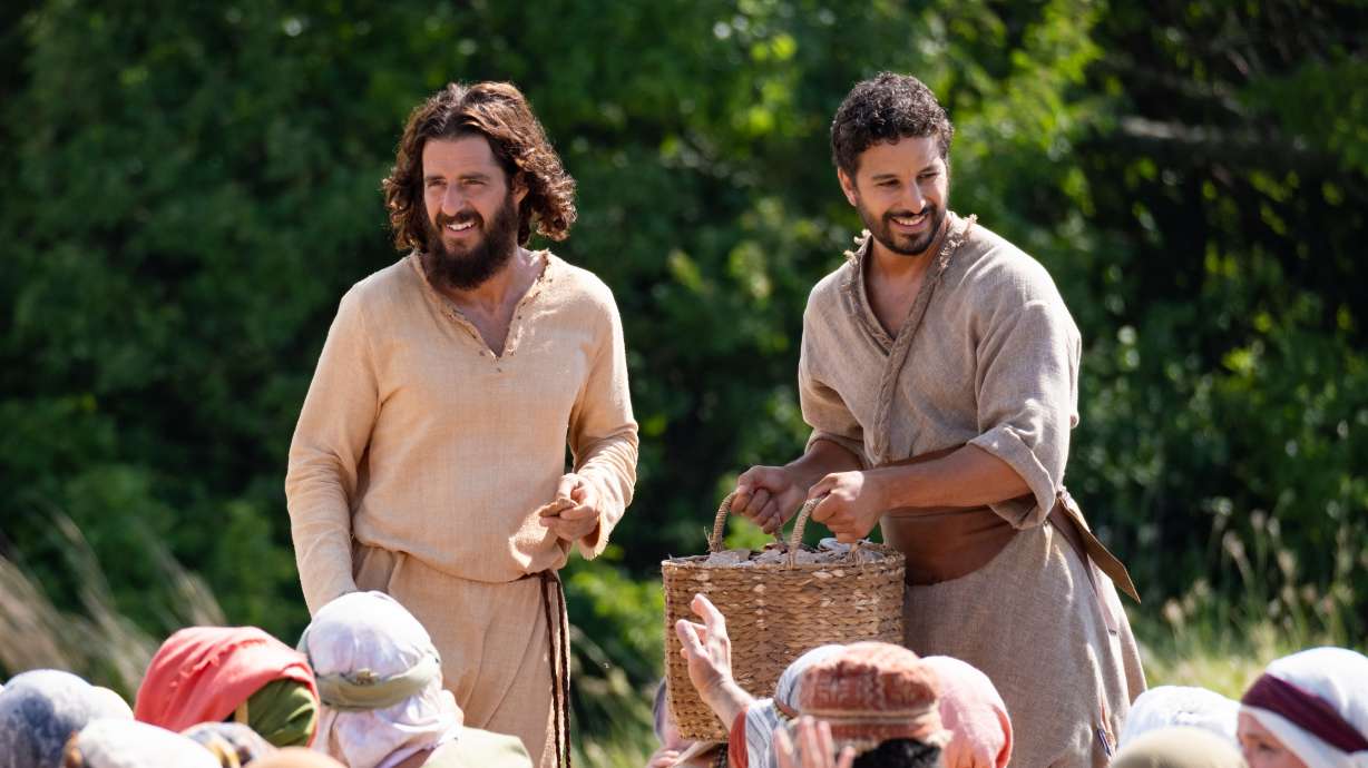 Actors Jonathan Roumie, who plays Jesus, and Alaa Safi, who plays Simon the Zealot, film the feeding of the 5,000 scene for “The Chosen.”