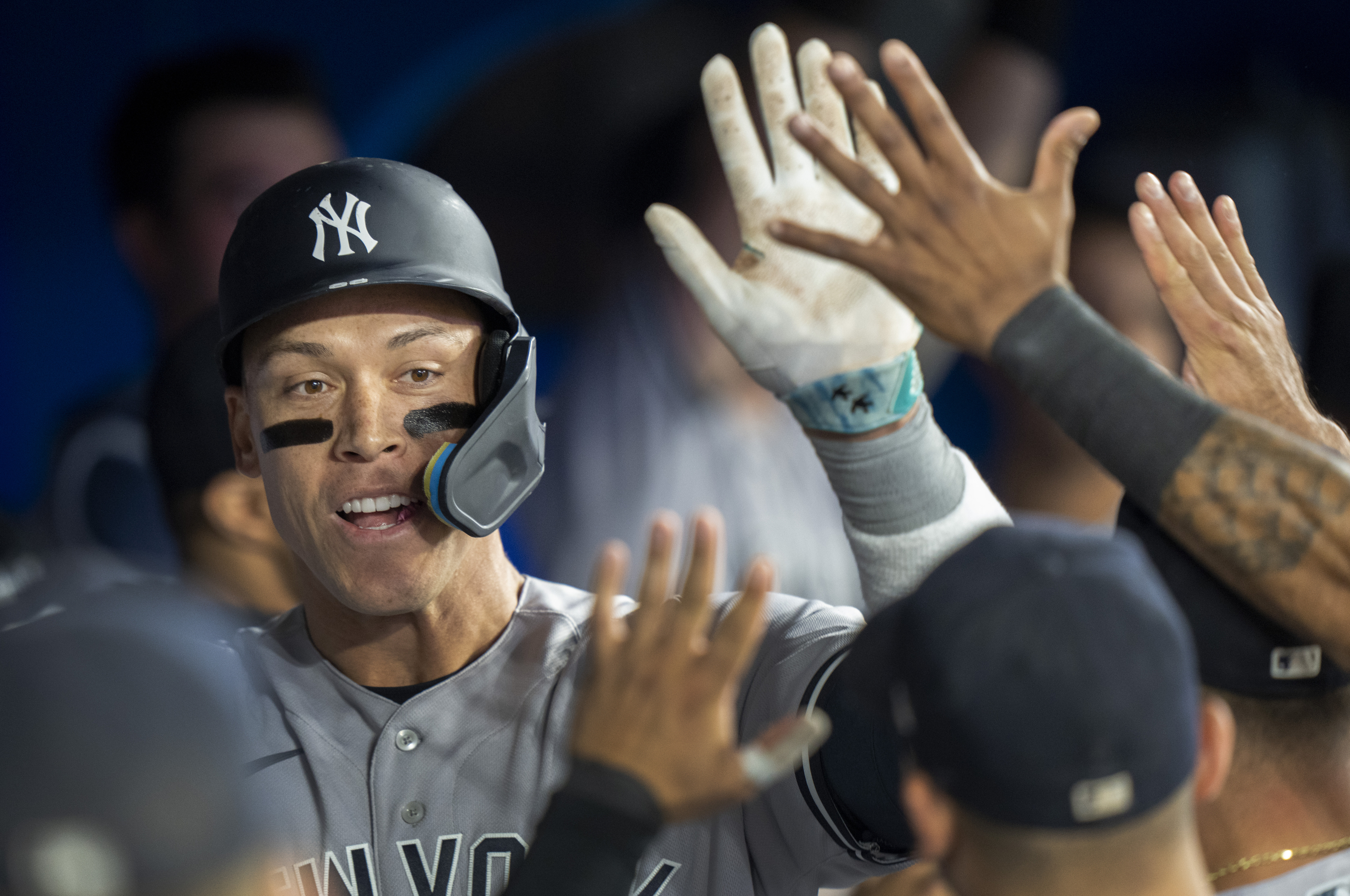 New York Yankees' Aaron Judge is congratulated by teammates after hitting his second home run of a baseball game, during eighth-inning action against the Toronto Blue Jays in Toronto, Ontario, Monday, May 15, 2023. 