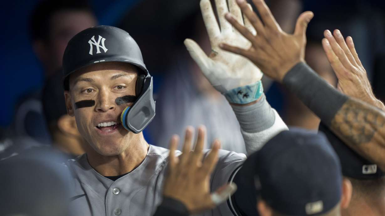 New York Yankees' Aaron Judge is congratulated by teammates after hitting his second home run of a baseball game, during eighth-inning action against the Toronto Blue Jays in Toronto, Ontario, Monday, May 15, 2023.