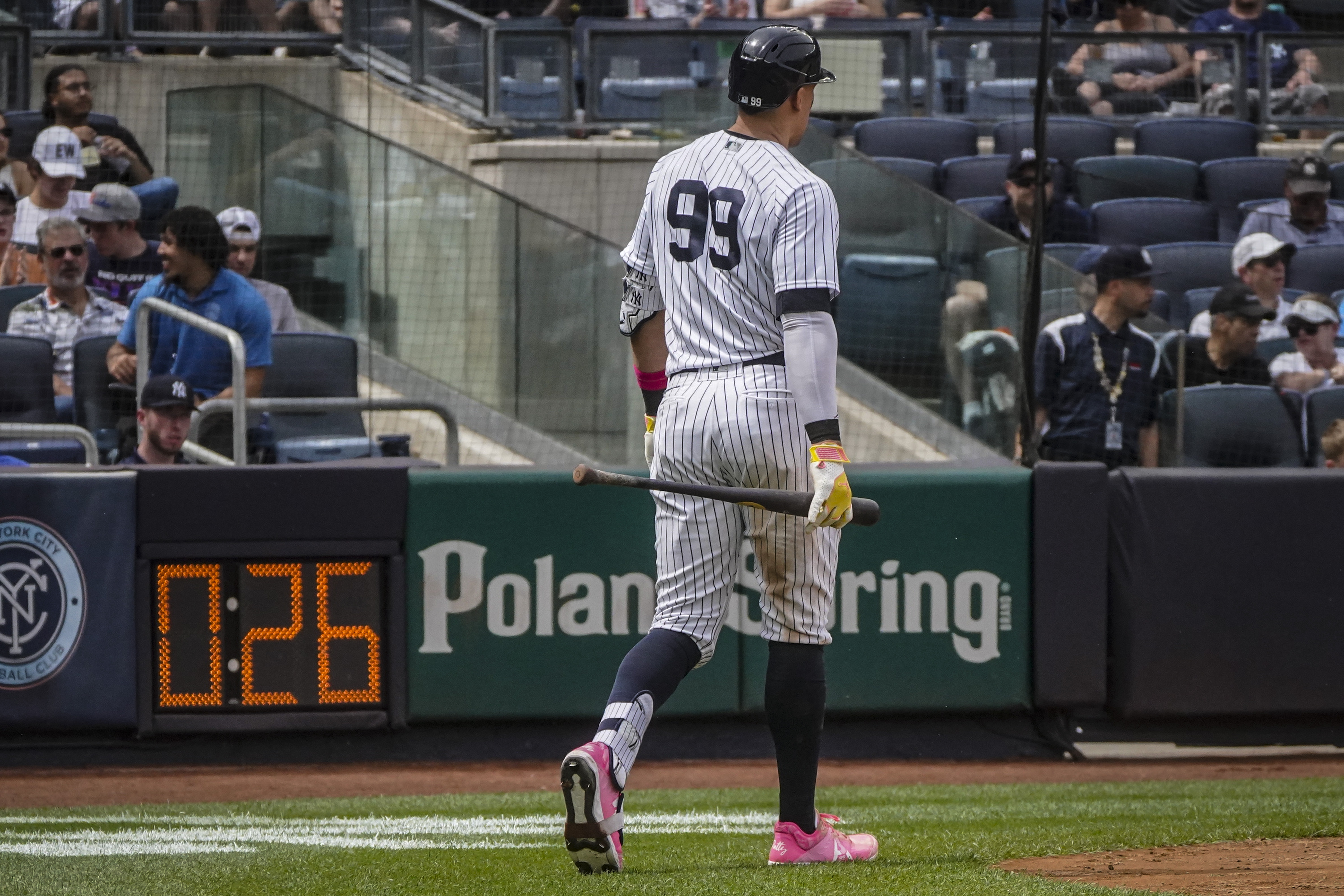 New York Yankees' Aaron Judge walk past the countdown clock before hitting a two-run home run during the fifth inning of a baseball game against the Tampa Bay Rays, Saturday, May 13, 2023, in New York. 