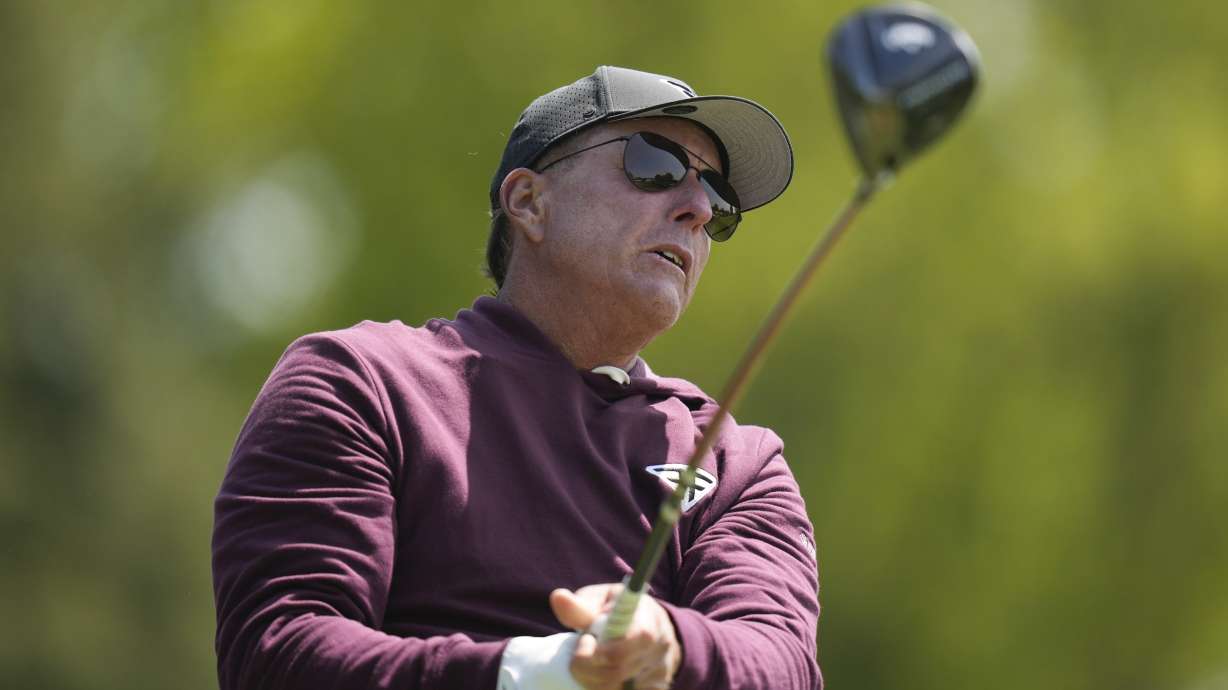 Phil Mickelson watches his tee shot on the fourth hole during a practice round for the PGA Championship golf tournament at Oak Hill Country Club on Wednesday, May 17, 2023, in Pittsford, N.Y.