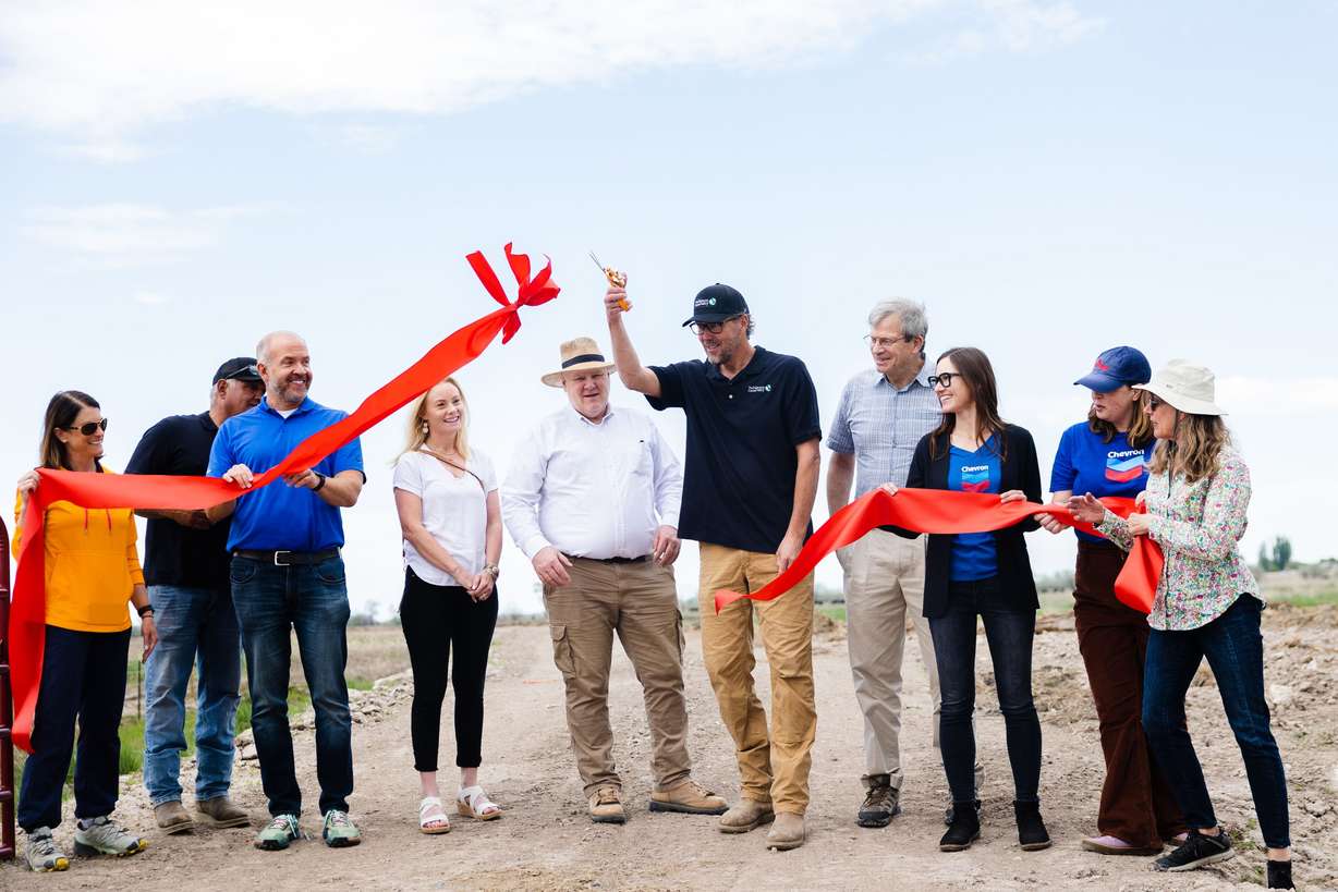 Dave Livermore, Utah director for The Nature Conservancy, and Chris Brown, the group’s director of stewardship, join others in a ribbon-cutting after the completion of the Freeport Drain project at the Great Salt Lake Shorelands Preserve in Layton on Wednesday.