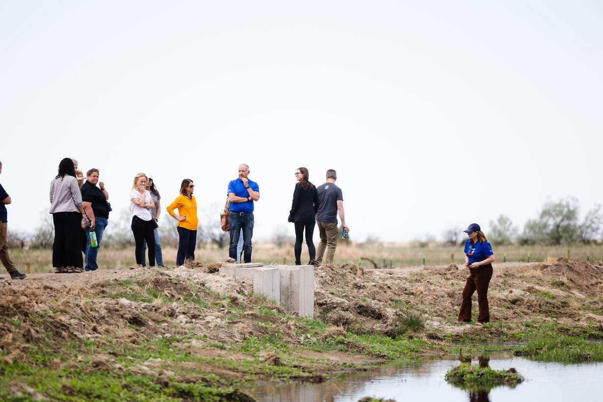 Visitors walk around the new wetlands following the completion of the Freeport Drain project at the Great Salt Lake Shorelands Preserve in Layton on Wednesday.