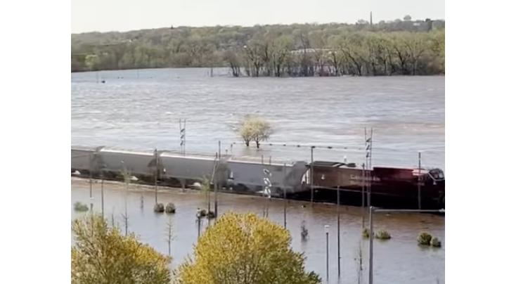 A locomotive pushes through floodwaters of the Mississippi River in Davenport, Iowa.