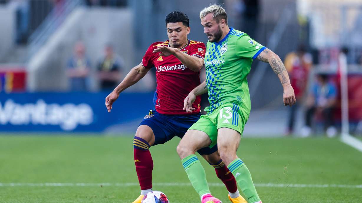Real Salt Lake defender Brayan Vera (4) and Seattle Sounders forward Jordan Morris (13) battle for the ball during a MLS match between Real Salt Lake and the Seattle Sounders at America First Field in Sandy on April 29, 2023.