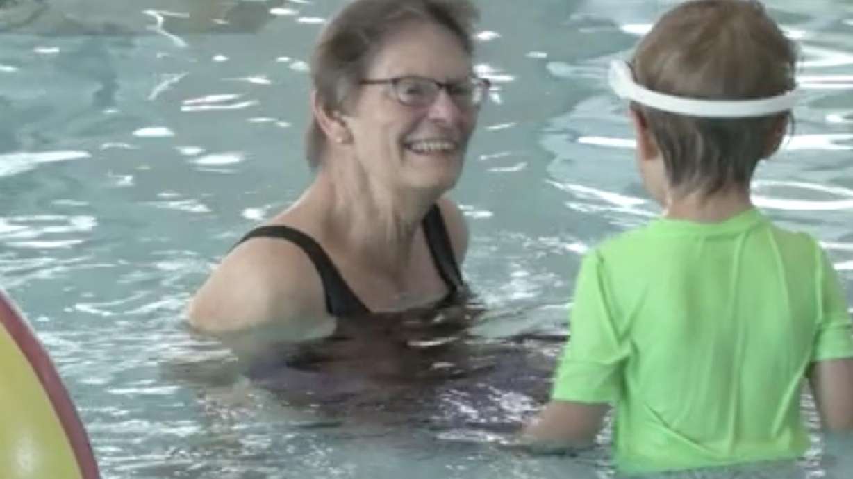 Cindy Richardson plays with her grandson Henry, wearing a WAVE Drowning Detection Systems headset, at the Clearfield Aquatics and Fitness Center on May 2. Clearfield has adopted WAVE as a public safety measure to help prevent drownings.