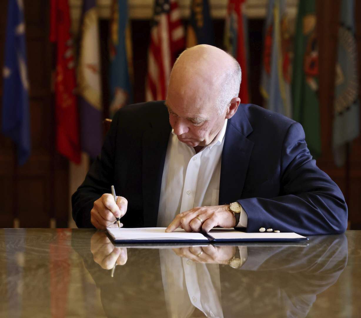 Republican Gov. Greg Gianforte signs a law banning TikTok in the state, Wednesday, in Helena, Mont. That law made Montana became the first state in the U.S. to completely ban TikTok.