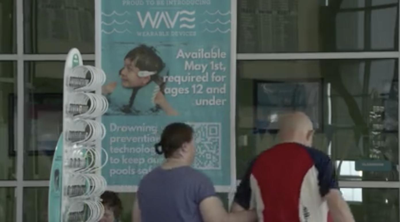 A sign at the Clearfield Aquatics and Fitness Center alerts patrons that swimmers ages 12 and younger have to wear WAVE Drowning Detection Systems headsets to swim at the pool.