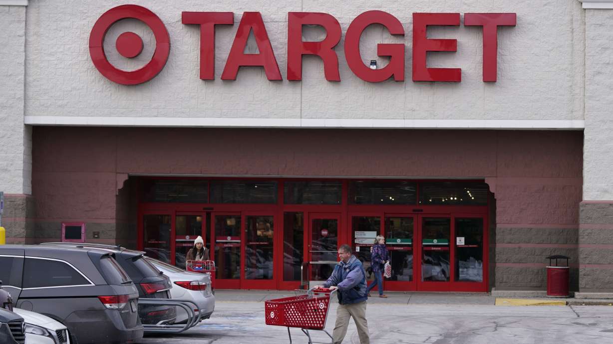 A shopper wheels a cart through the parking lot after making a purchase at the Target store, Feb. 27, in Salem, N.H. Target is recalling almost 5 million candles over laceration and burn hazards, according to a Thursday notice published by the U.S. Consumer Product Safety Commission.