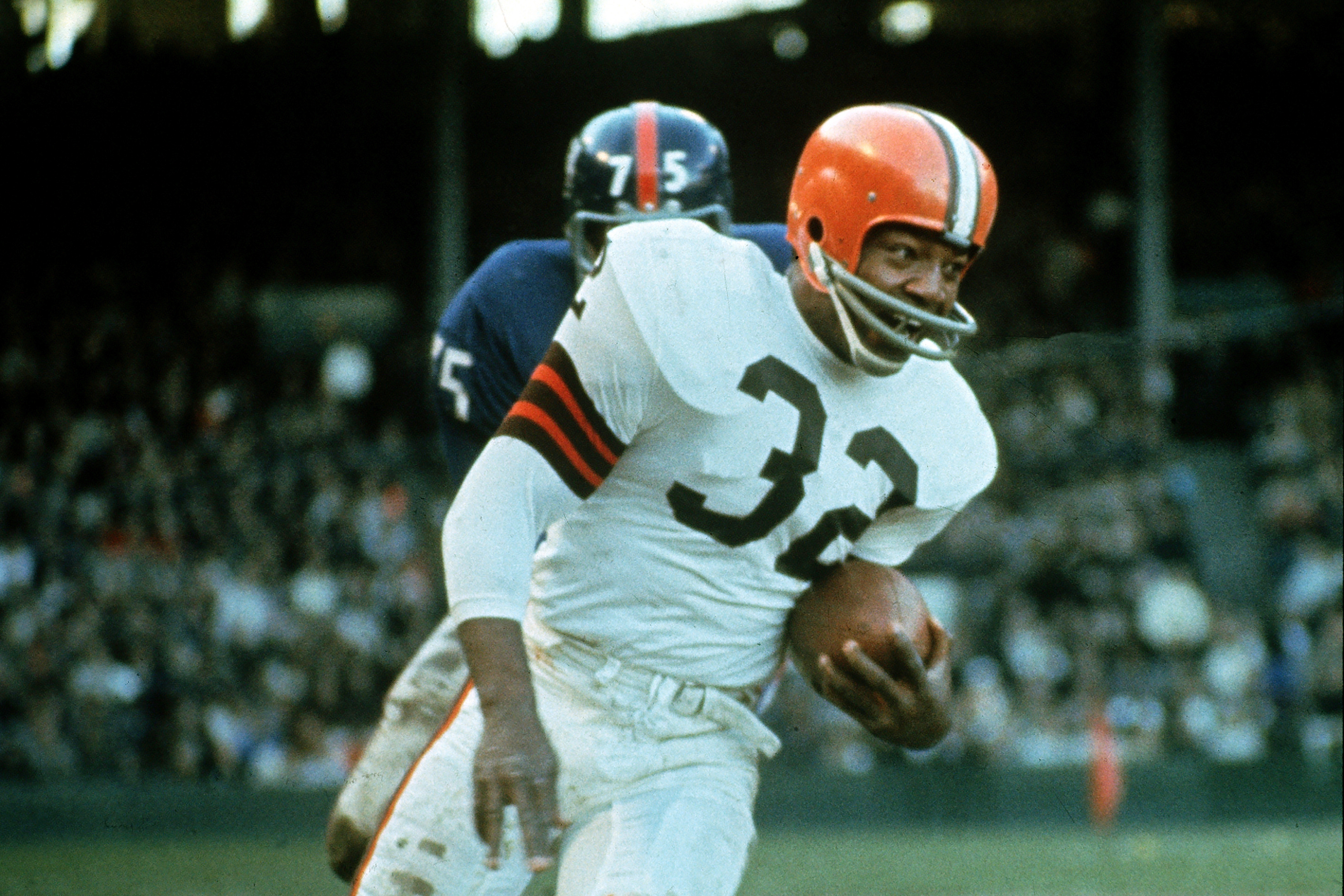 Jimmy Brown (32), running back for the Cleveland Browns, is shown in action against the New York Giants in Cleveland, Ohio, on Nov. 14, 1965. NFL legend, actor and social activist Jim Brown passed away peacefully in his Los Angeles home on Thursday night, May 18, 2023, with his wife, Monique, by his side, according to a spokeswoman for Brown's family. He was 87.