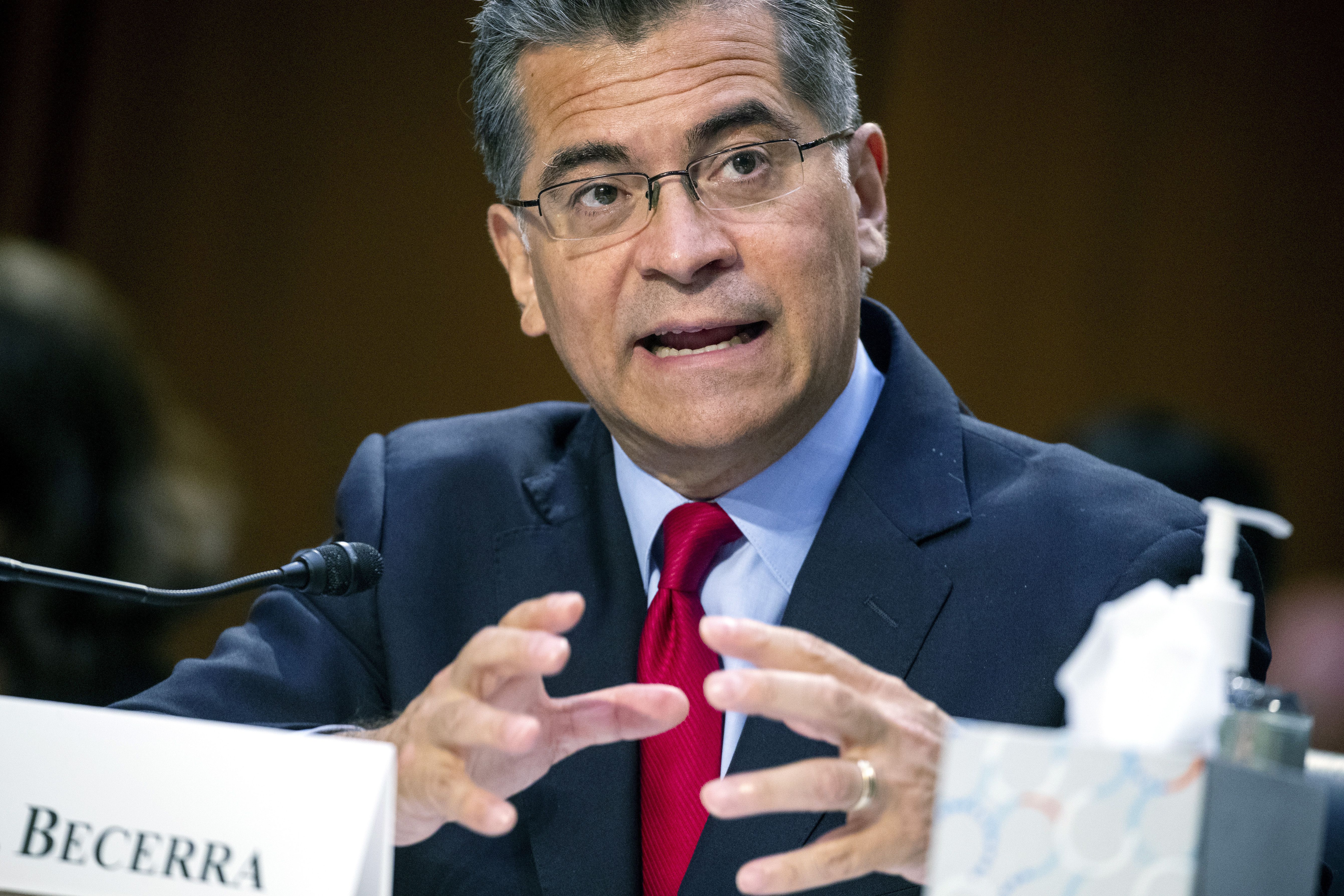Secretary of Health and Human Services Xavier Becerra testifies before a Senate Health, Education, Labor, and Pensions Committee hearing, Sept. 30, 2021 on Capitol Hill in Washington. Becerra is ordering Medicare to reassess a big premium increase facing millions of seniors this year. The increase was largely attributed to a pricey new Alzheimer’s drug with questionable benefits. Becerra’s directive on Monday comes days after drugmaker Biogen slashed the price of its $56,000-a-year medication, Aduhelm, to $28,200 a year — a cut of about half.