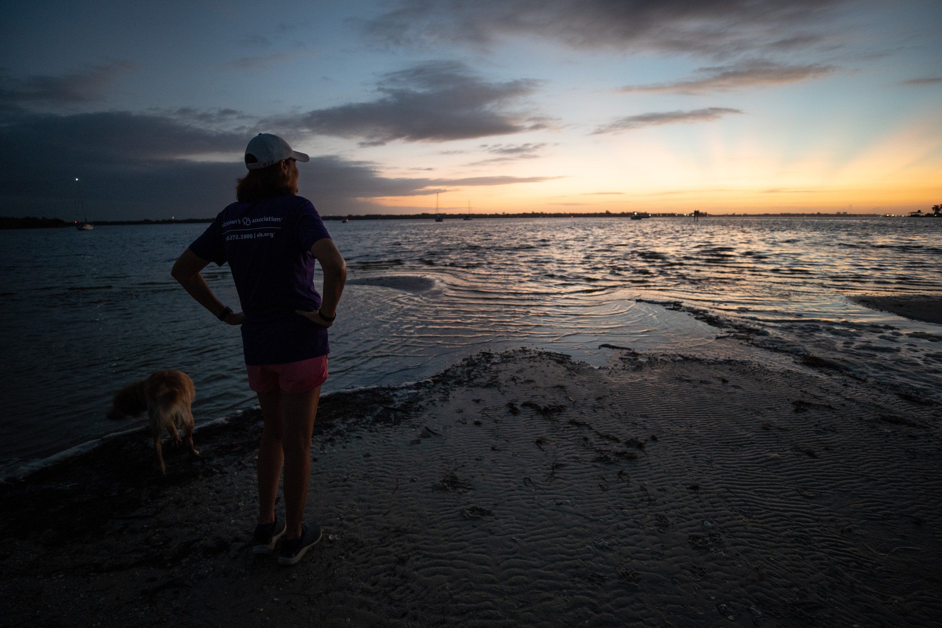 Michele Hall, 55, of Bradenton, Fla., watches the sunrise during her morning walk at the De Soto National Memorial on Sunday, Sept. 25, 2022, in Bradenton. Hall was diagnosed with Alzheimer’s disease when she was 53. “I can’t read or write or any of that stuff. But I can talk.”