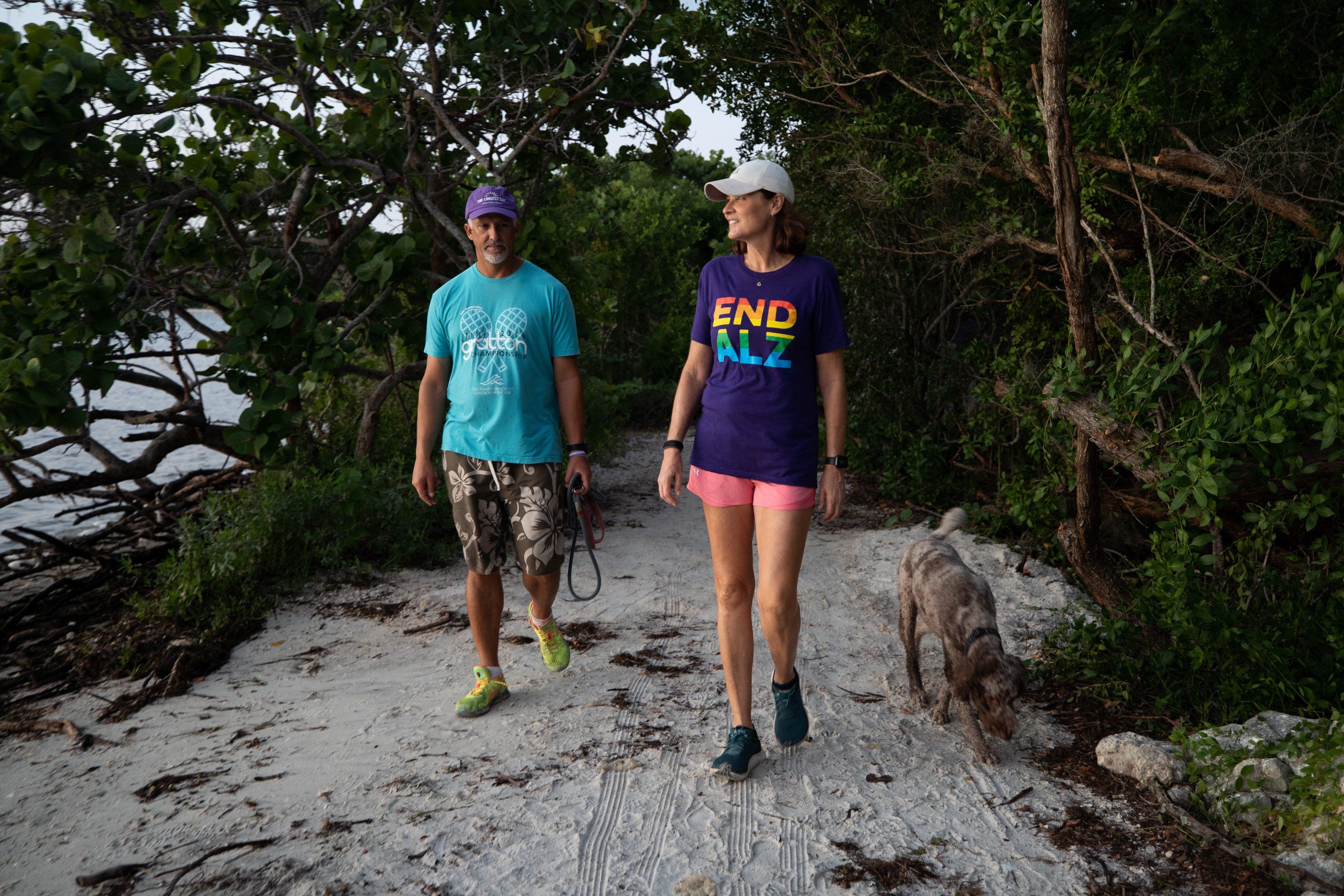 Michele Hall, 55, of Bradenton, Fla., goes on a morning walk with her husband, Doug, at the De Soto National Memorial on Sunday, Sept. 25, 2022, in Bradenton. Michele Hall was diagnosed with Alzheimer’s disease when she was 53. “I can’t read or write or any of that stuff. But I can talk.”