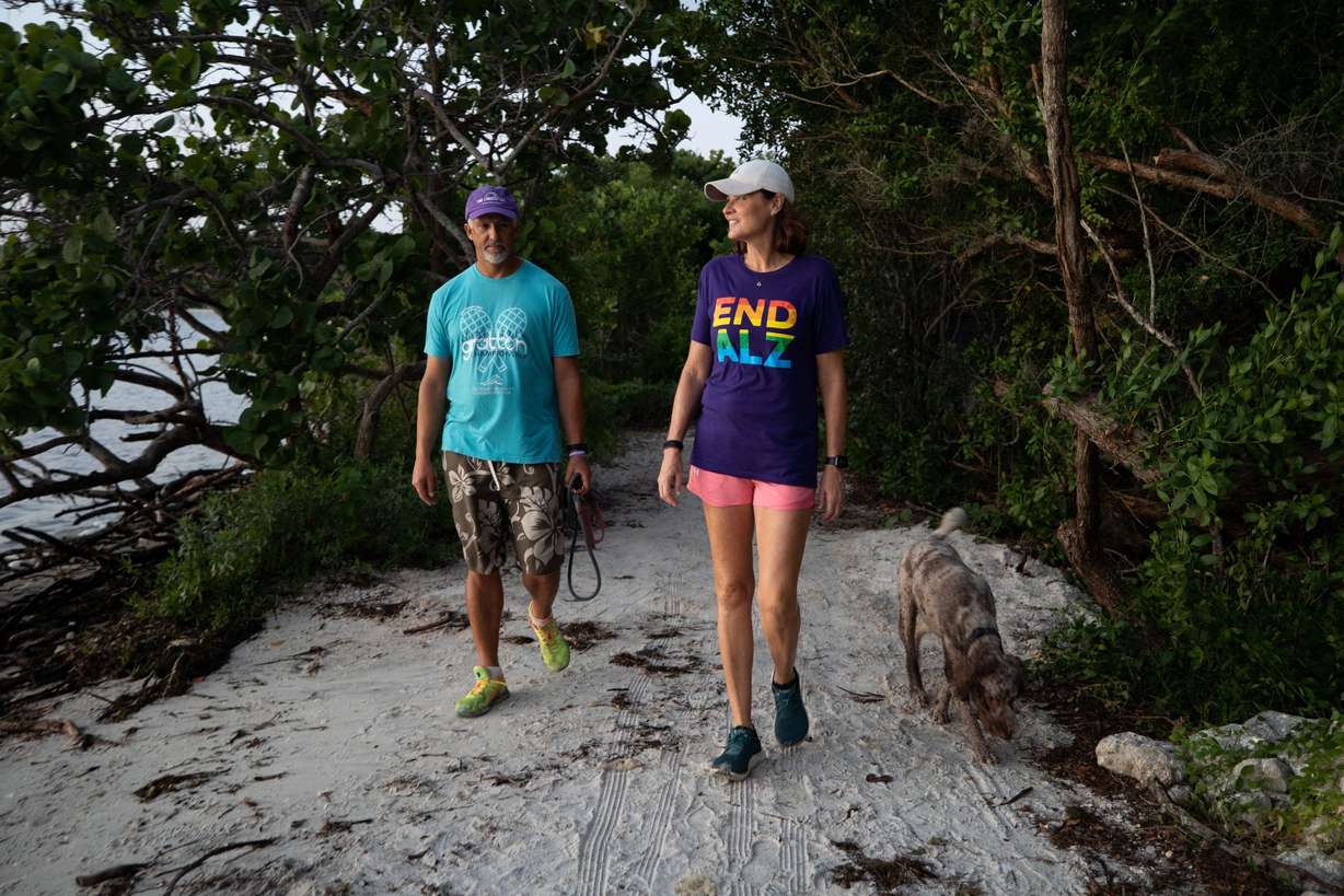 Michele Hall, 55, of Bradenton, Fla., goes on a morning walk with her husband, Doug, at the De Soto National Memorial on Sunday, Sept. 25, 2022, in Bradenton. Michele Hall was diagnosed with Alzheimer’s disease when she was 53. “I can’t read or write or any of that stuff. But I can talk.”