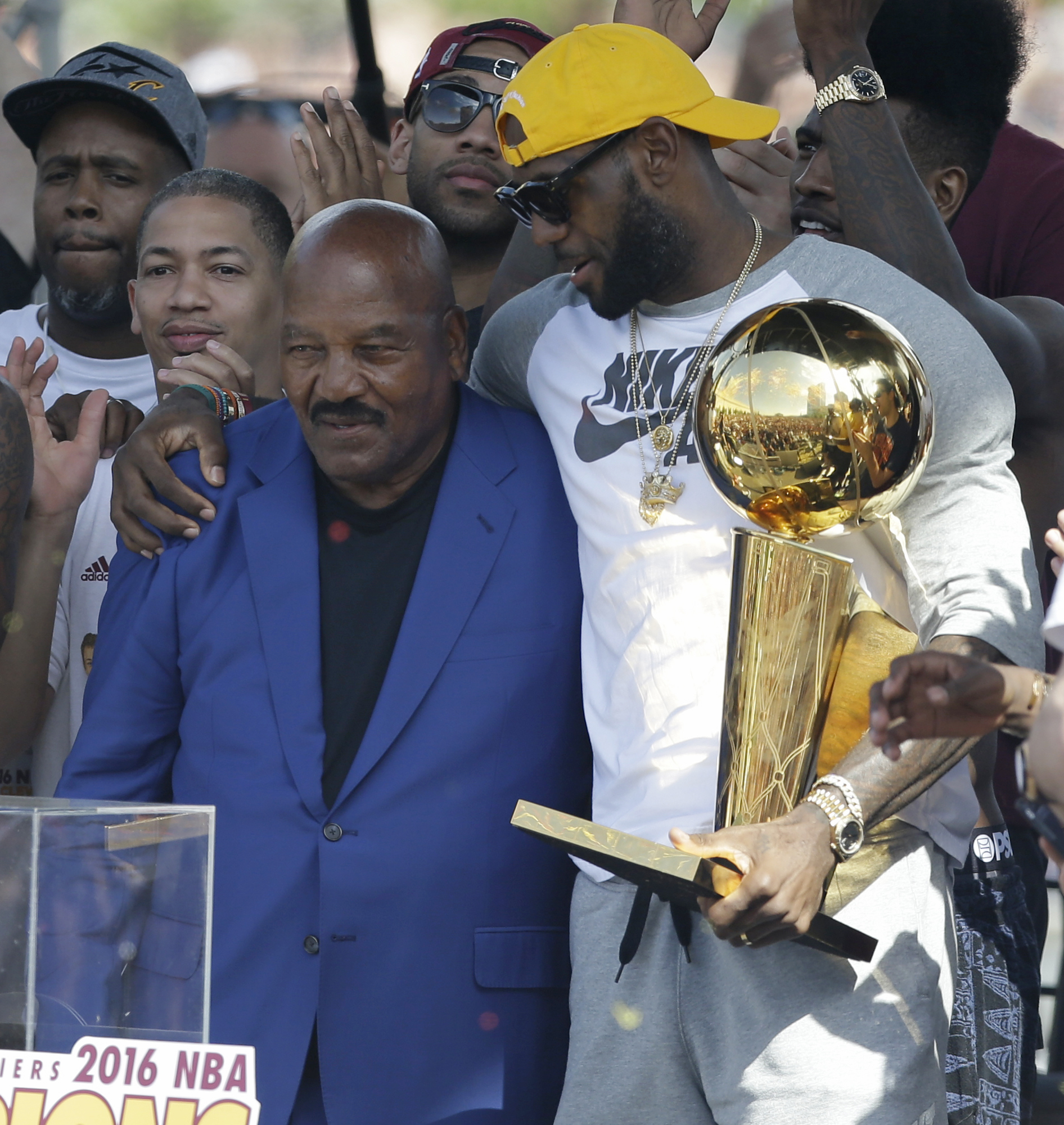 FILE - Former Cleveland Browns player Jim Brown, left, gets a hug from LeBron James, who holds the Larry O'Brien NBA championship trophy during a rally June 22, 2016, in Cleveland. “I hope every Black athlete takes the time to educate themselves about this incredible man and what he did to change all of our lives,” James posted shortly after Brown's death. ”We all stand on your shoulders Jim Brown. If you grew up in Northeast Ohio and were Black, Jim Brown was a God." 