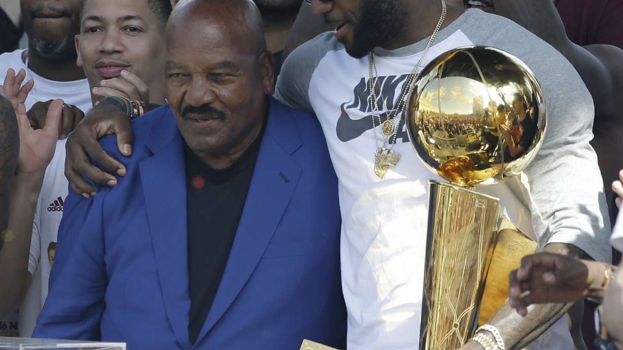 FILE - Former Cleveland Browns player Jim Brown, left, gets a hug from LeBron James, who holds the Larry O'Brien NBA championship trophy during a rally June 22, 2016, in Cleveland. “I hope every Black athlete takes the time to educate themselves about this incredible man and what he did to change all of our lives,” James posted shortly after Brown's death. ”We all stand on your shoulders Jim Brown. If you grew up in Northeast Ohio and were Black, Jim Brown was a God."
