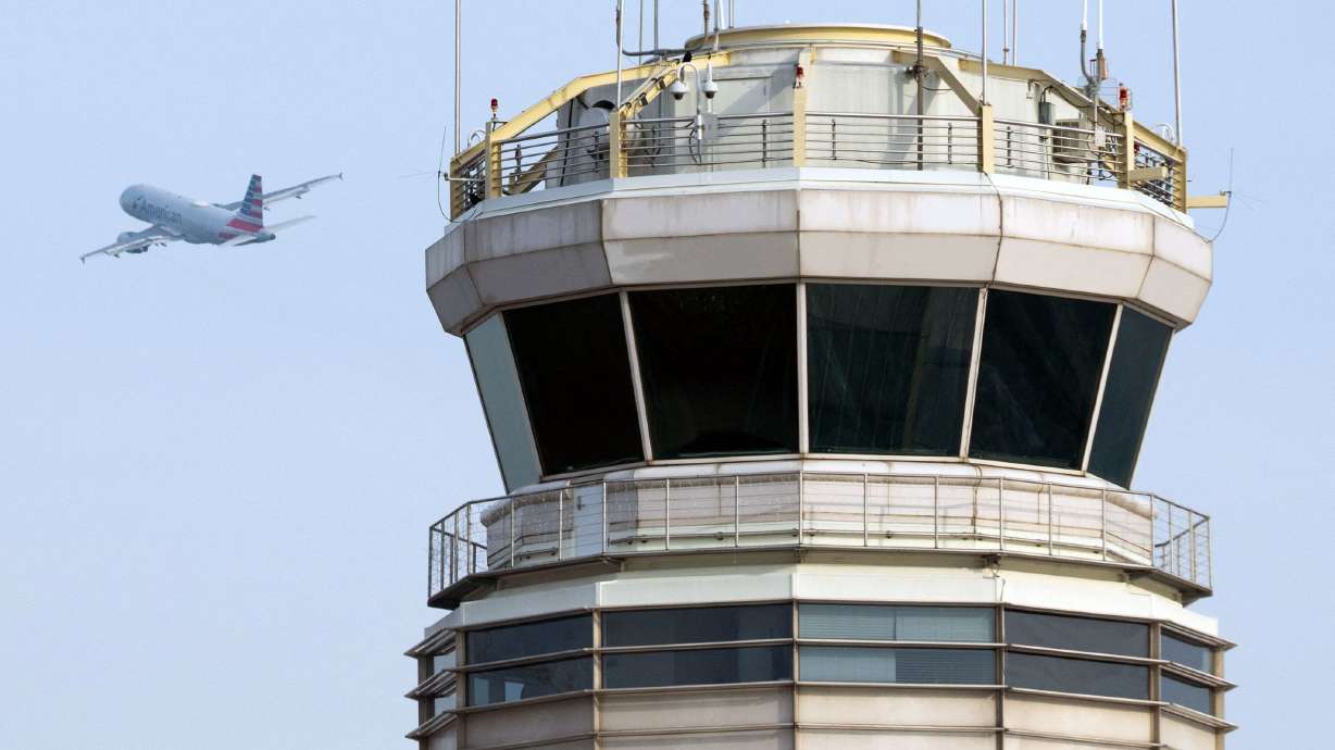 An American Airlines Airbus A319 airplane takes off past the air traffic control tower at Ronald Reagan Washington National Airport in Arlington, Virginia, in January.